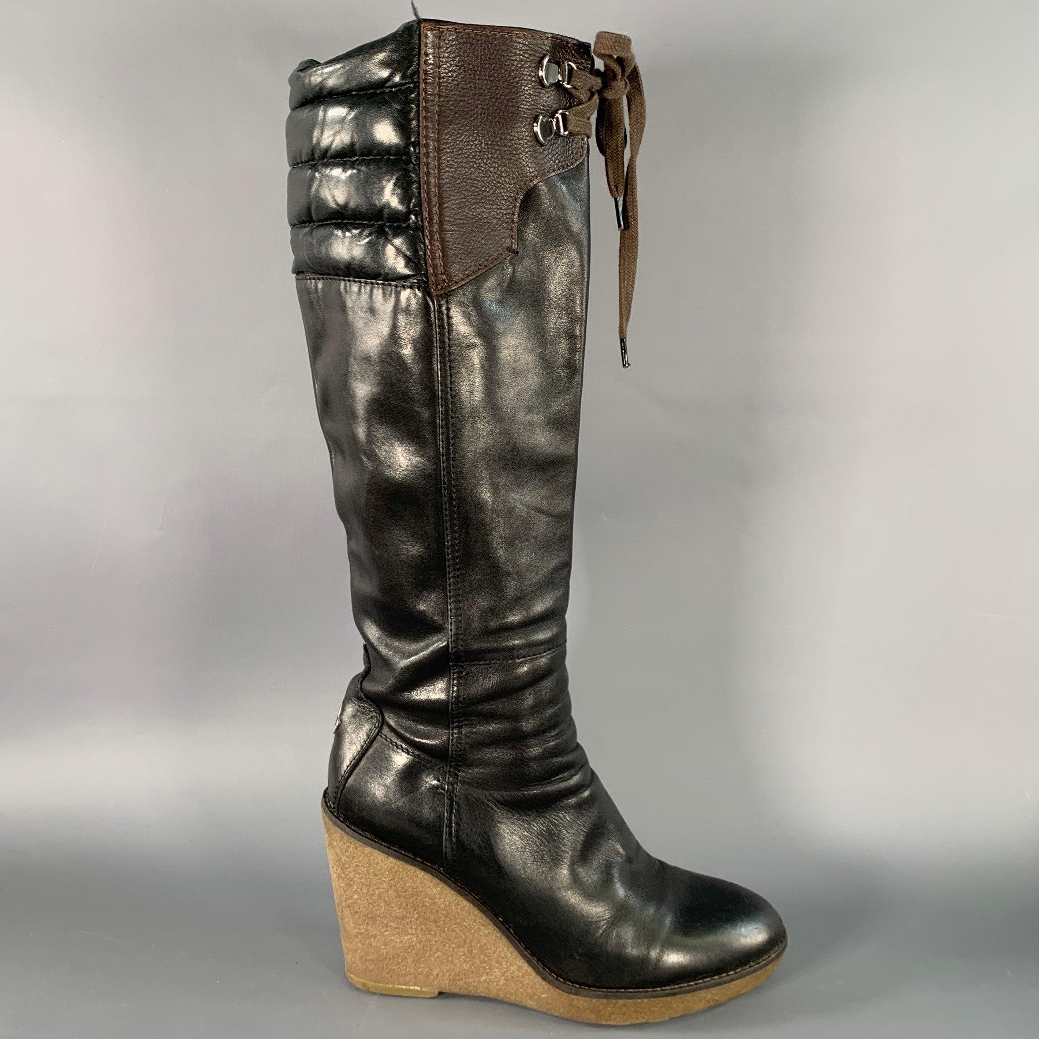 MONCLER
boots in a black leather with brown pebble grain leather panel featuring a knee high style, crepe sole wedge heel, and side zipper closure with tie on front. Made in Italy.Good Pre-Owned Condition. Multiple scuffs and signs of wear.