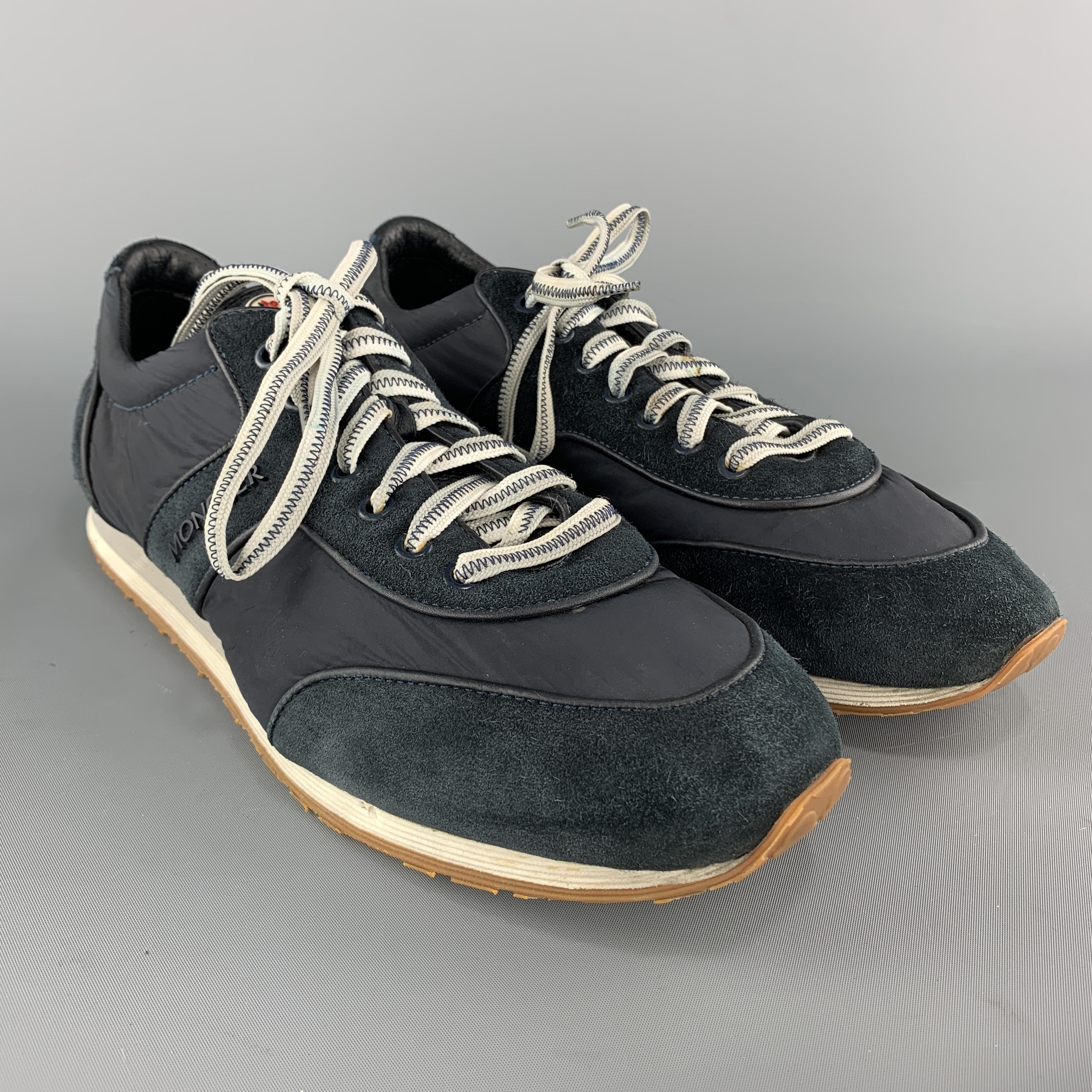 MONCLER trainers come in muted navy blue suede with nylon panels and multi color sole. Made in Italy.

Very Good Pre-Owned Condition.
Marked: IT 43

Outsole: 11.5 x 4 in.