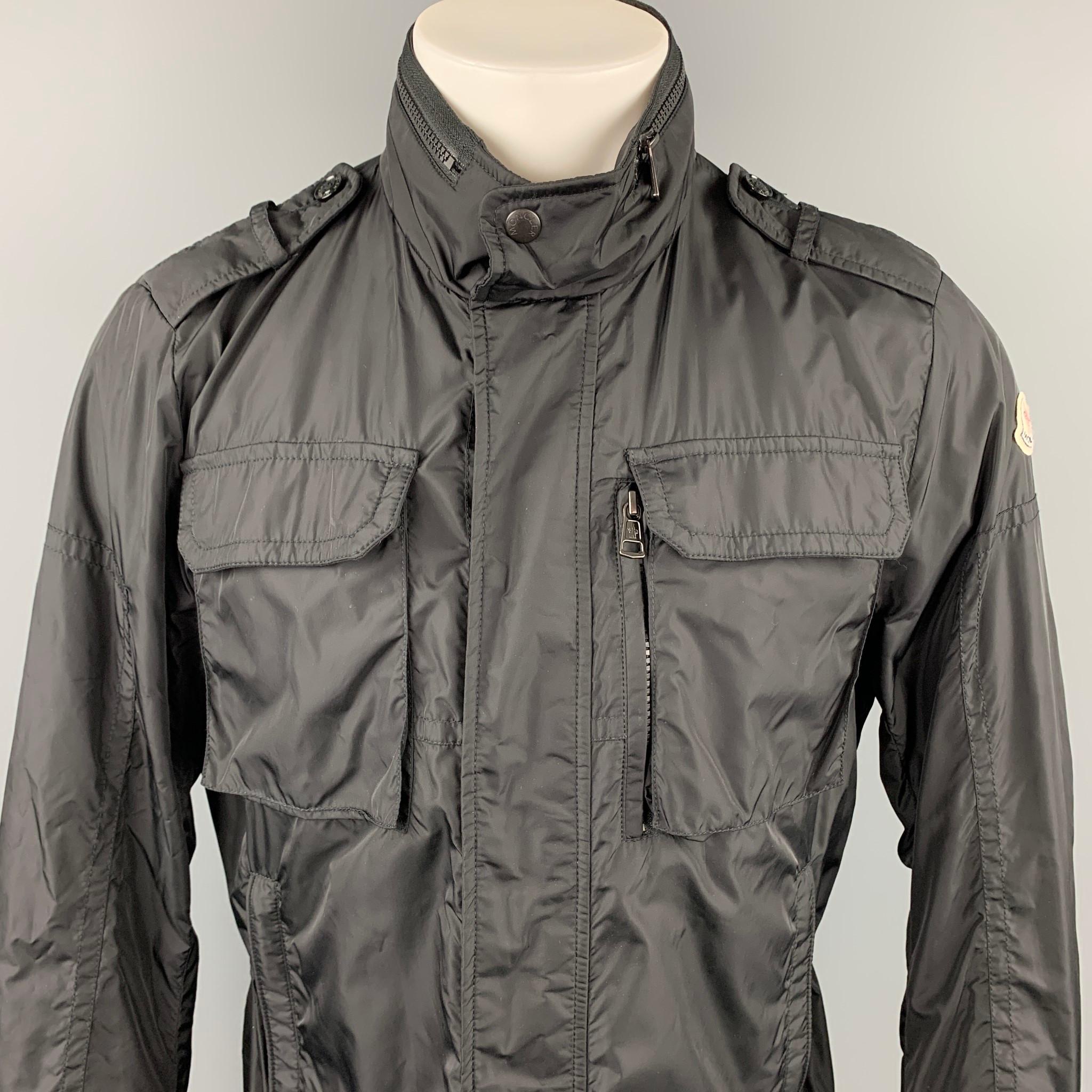 MONCLER jacket comes in a black polyamide featuring a removable hood, patch pockets, and a zip & snap button closure. Made in Romania.

Very Good Pre-Owned Condition.
Marked: 3

Measurements:

Shoulder: 18 in.
Chest: 42 in.
Sleeve: 26.5 in.
Length: