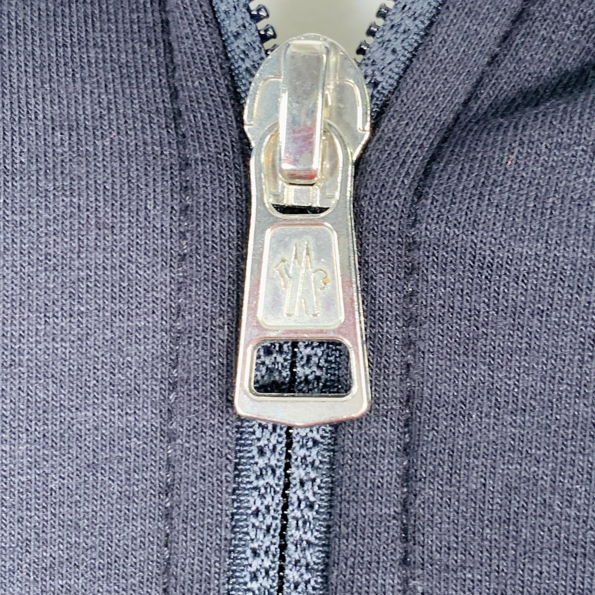 MONCLER jacket in a navy cotton blend featuring a hooded style with subtle logo trim, two snap pockets, and zip up closure.Very Good Pre-Owned Condition. Minor marks on front. 

Marked:   S 

Measurements: 
 
Shoulder: 18 inches Chest: 40 inches