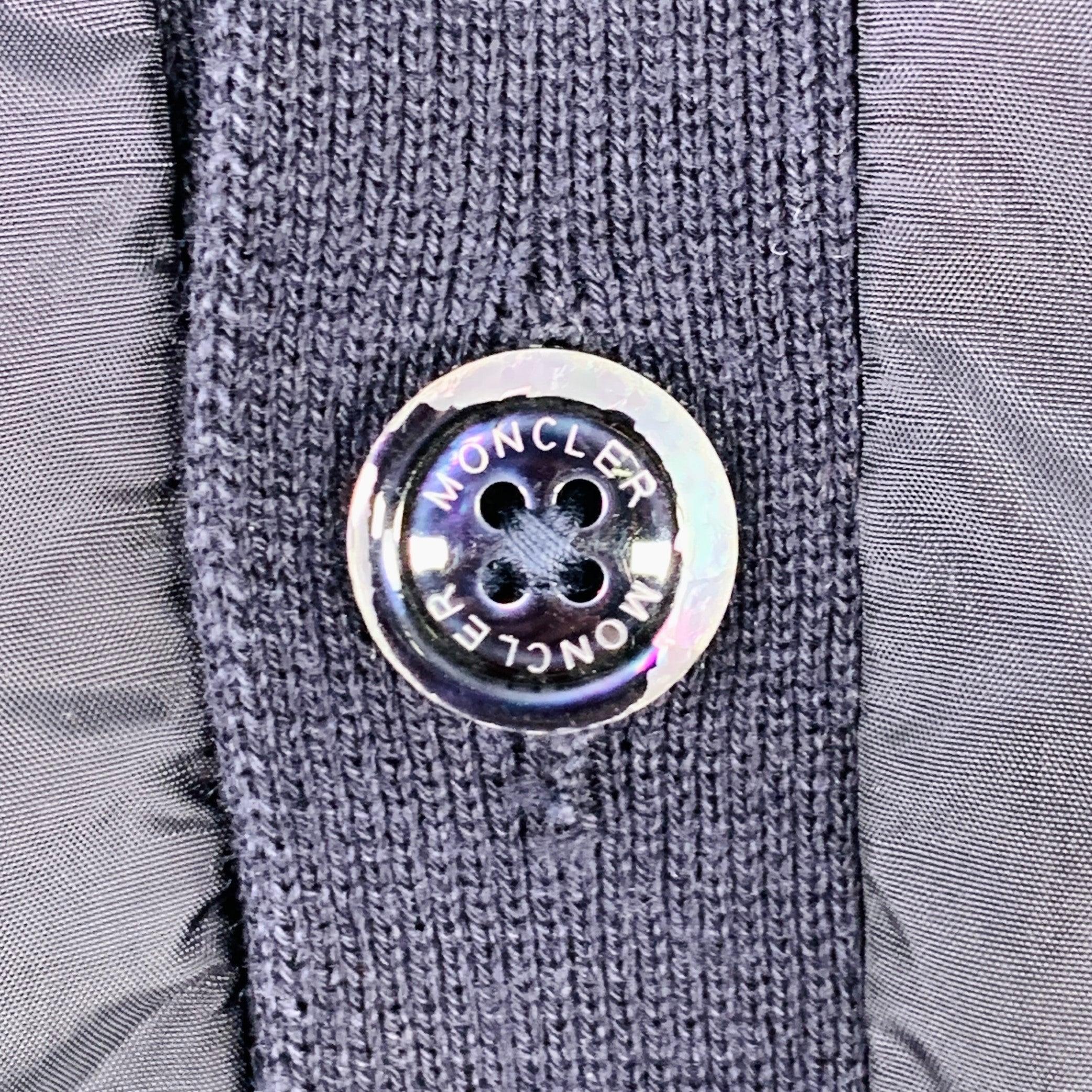 MONCLER cardigan in a navy polyamide featuring a mixed fabrics design with cotton knit sleeves, and button closure.Excellent Pre-Owned Condition. 

Marked:   S 

Measurements: 
 
Shoulder: 16 inches Chest: 39 inches Sleeve: 26 inches Length: 25