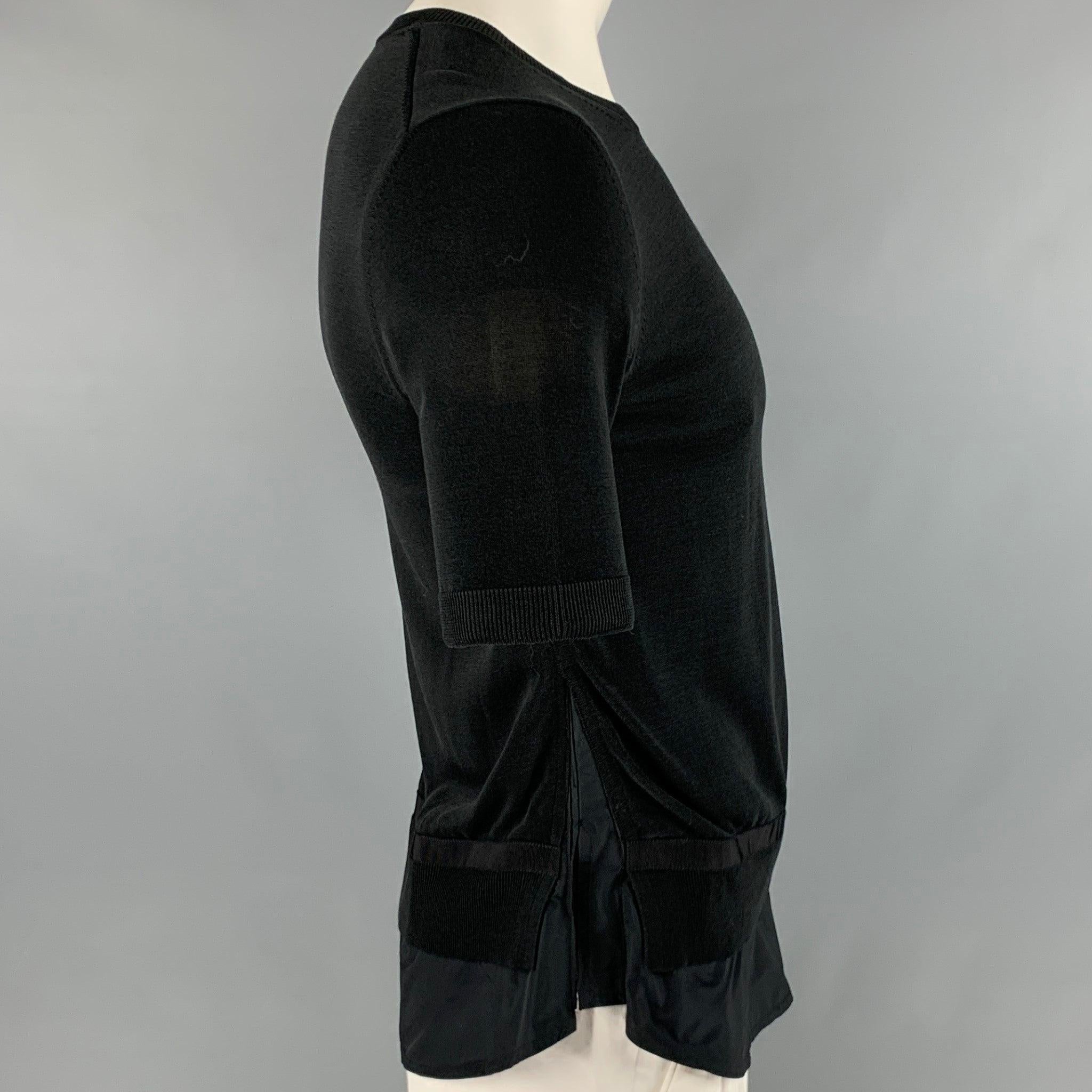 MONCLER pullover
in a
black viscose cotton blend featuring shirt tail detail, stretchy fit, and a scoop neck.Very Good Pre-Owned Condition. Busted stitch on left side of shirt tail. 

Marked:   XL 

Measurements: 
 
Shoulder: 18 inches Chest: 36