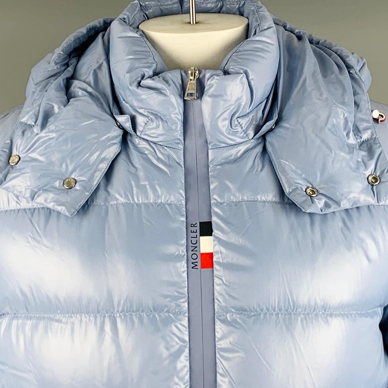 MONCLER jacket
in a light blue polyamide fabric featuring a quilted style, detachable hood, and zip up closure. Made in Romania.Very Good Pre-Owned Condition.
Minor mark. 

Marked:   G20911A00002 68950 

Measurements: 
 
Shoulder: 18 inches Chest: