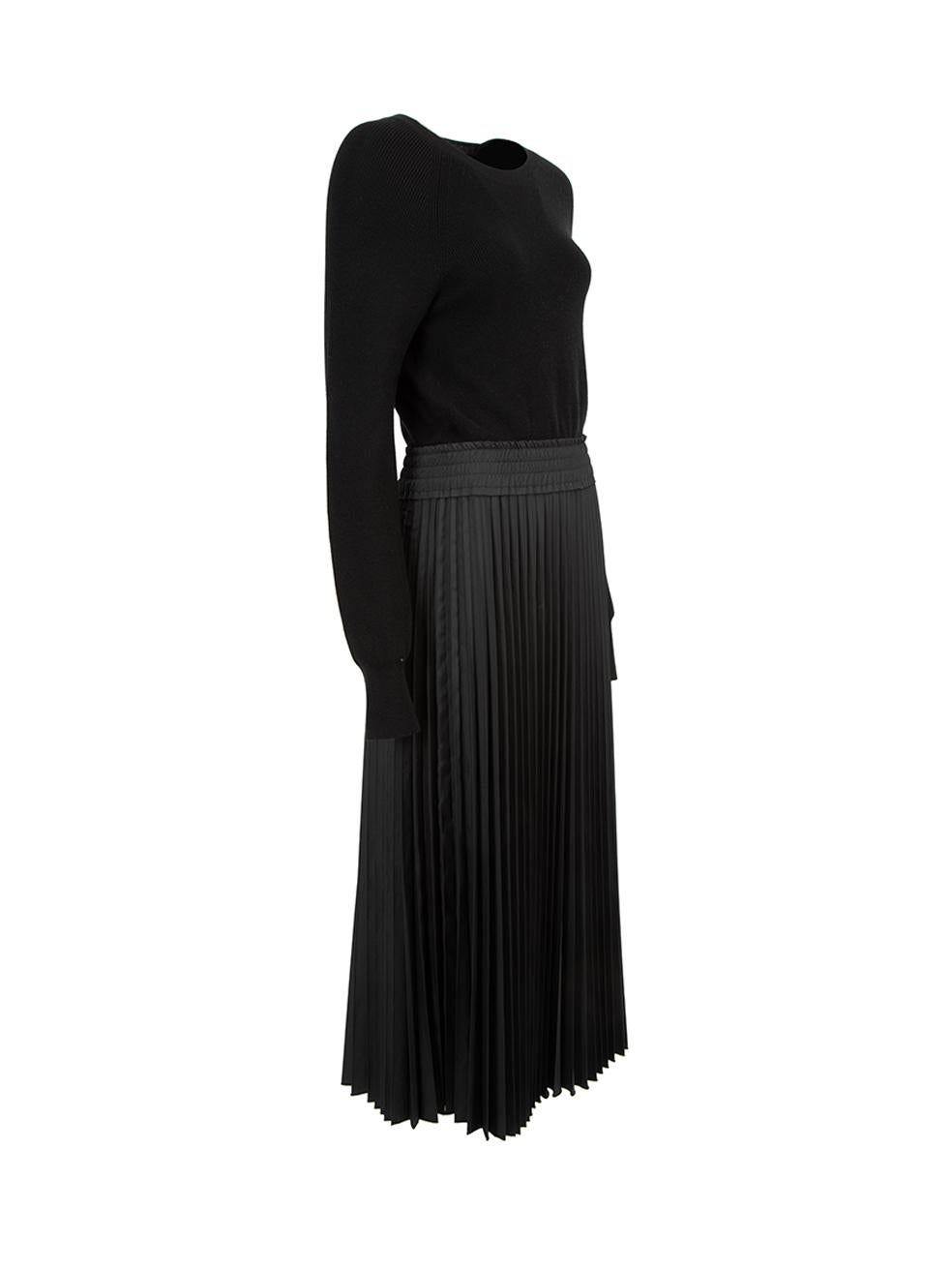 CONDITION is Never Worn. No visible wear to dress is evident on this used Moncler designer resale item.   Details  Black Wool Midi dress Knit long sleeves top Round neckline Pleated skirt Elasticated waistband and belted   Made in Romania 