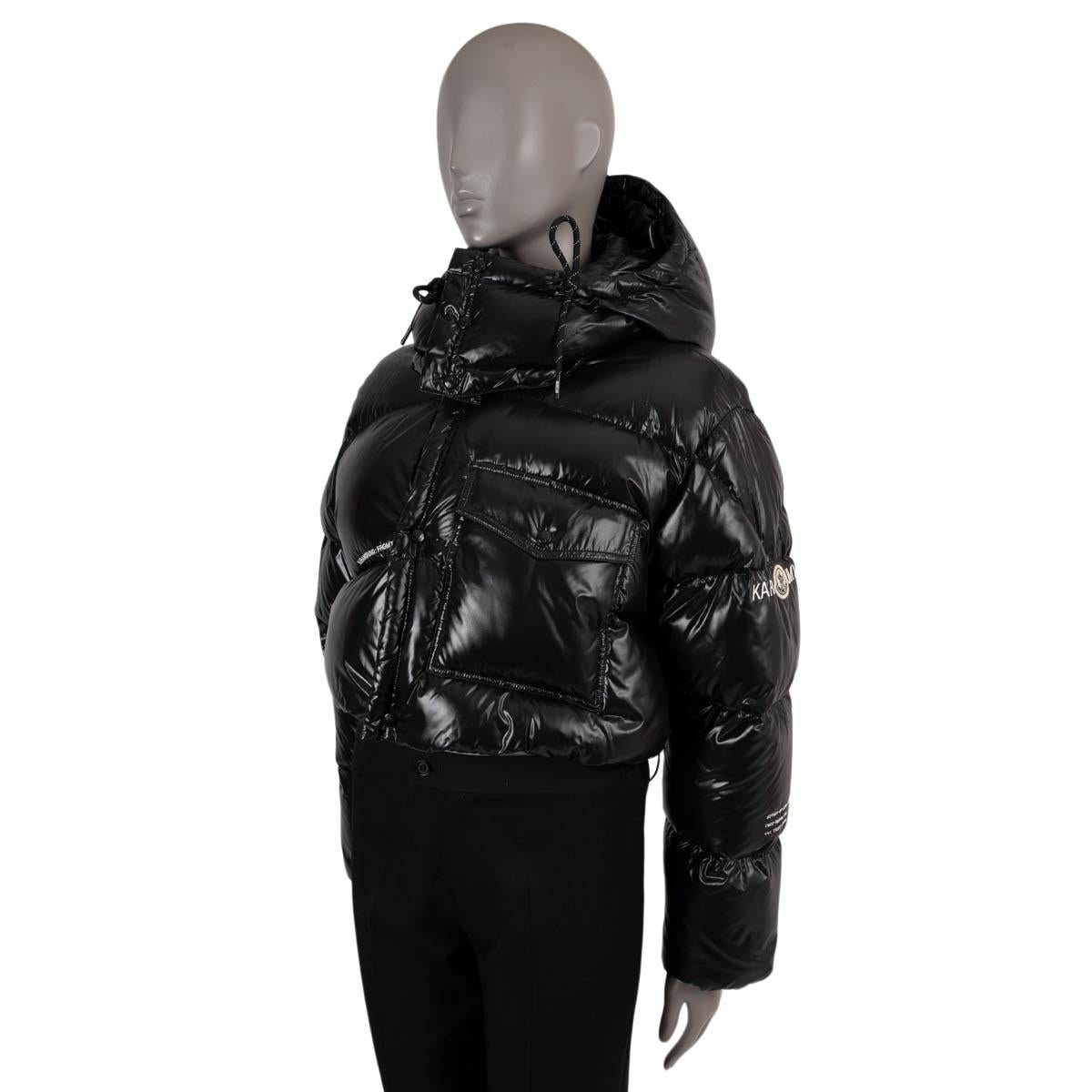 100% authentic Moncler Genius x FRGMT Irvinie down puffer jacket in black shiny satin polyamide (100%). Features a drawstring hood, stand-up collar, a flap pocket on the front, drawstring bottom hem and inset elastic cuffs. Opens with a two-way