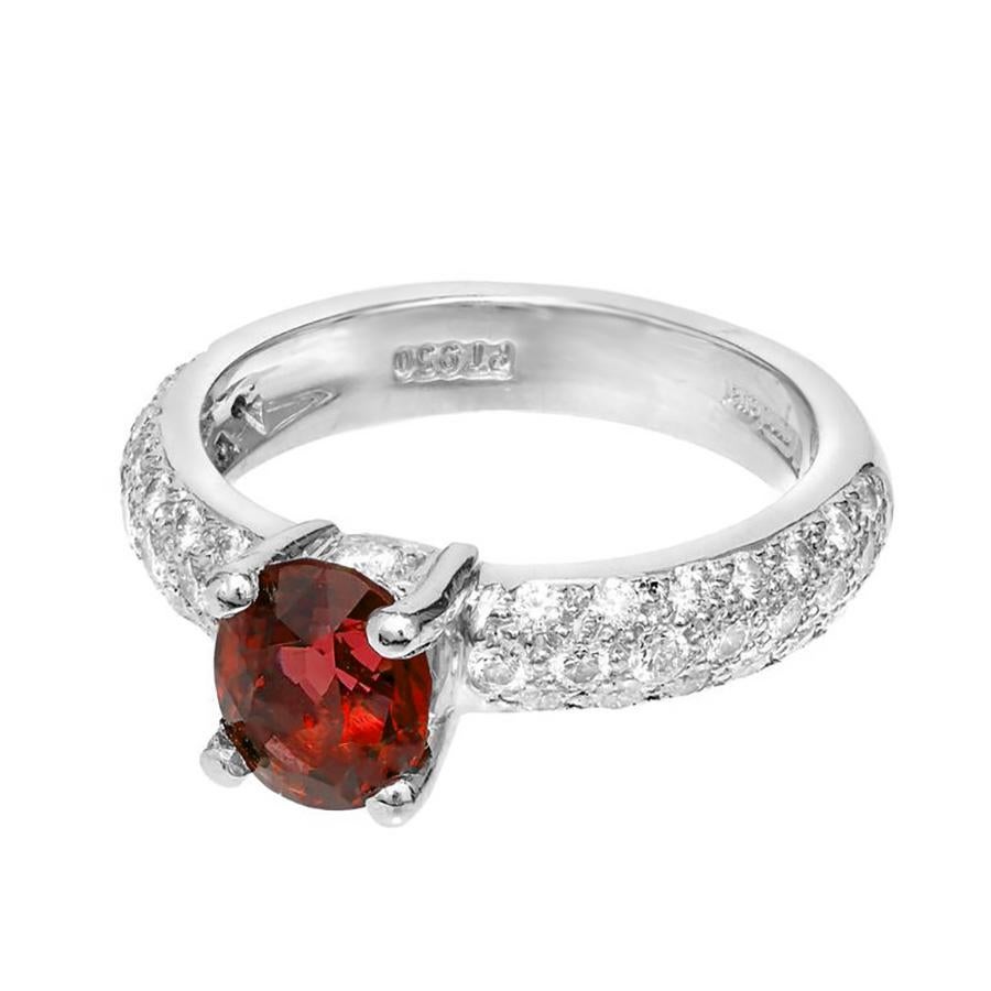 Mondera GIA Certified 1.59ct red Spinel and Diamond engagement ring. This exquisite piece features a vibrant red oval spinel center stone, weighing 1.59 carats. Mounted in a platinum setting, both shoulders of the ring are layered with 3 rows of