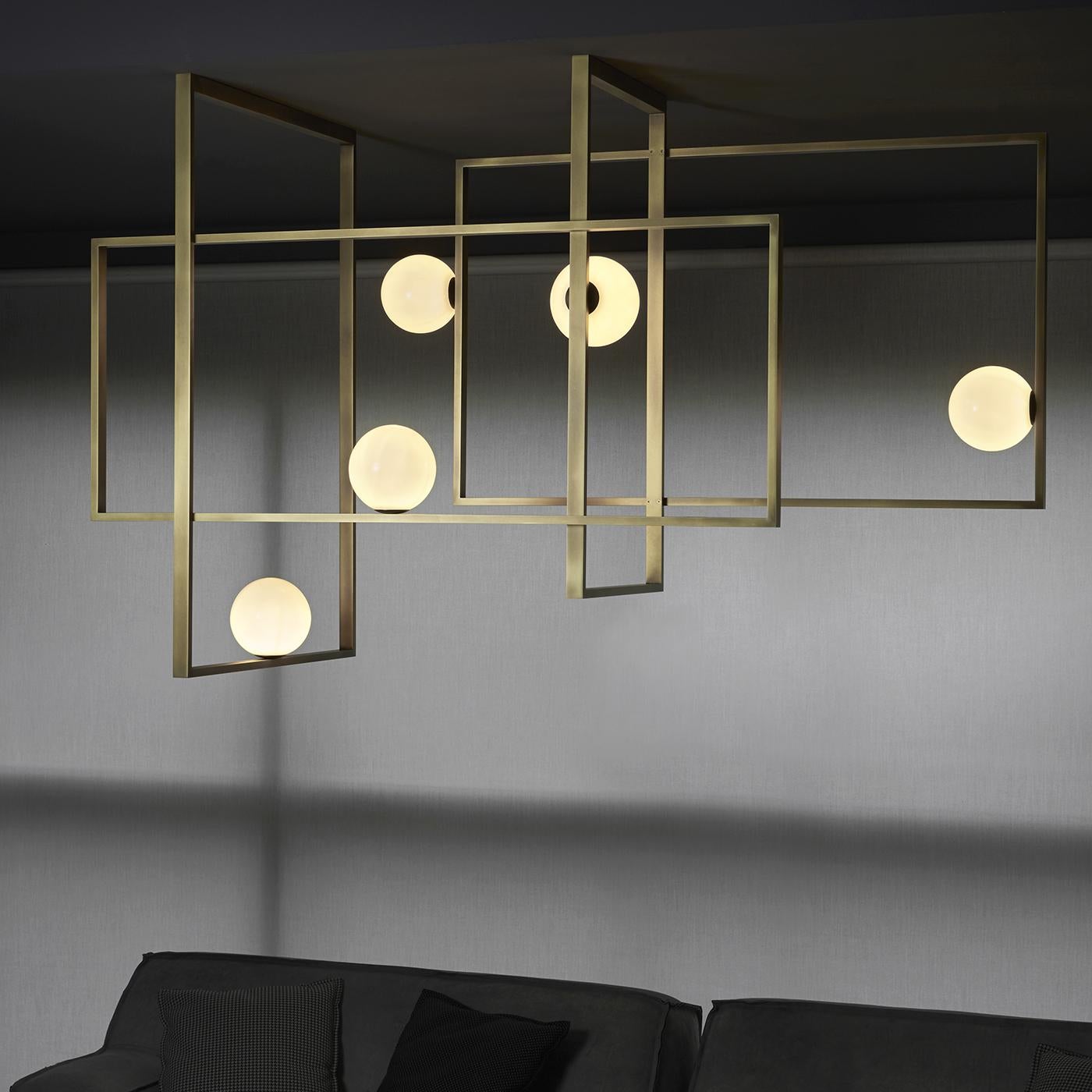 This striking chandelier features five mouth-blown Murano glass spheres in white. The elegant geometry of the metal structure is available with a burnished natural brass, polished black nickel, polished gold or matte black nickel finish. The wiring