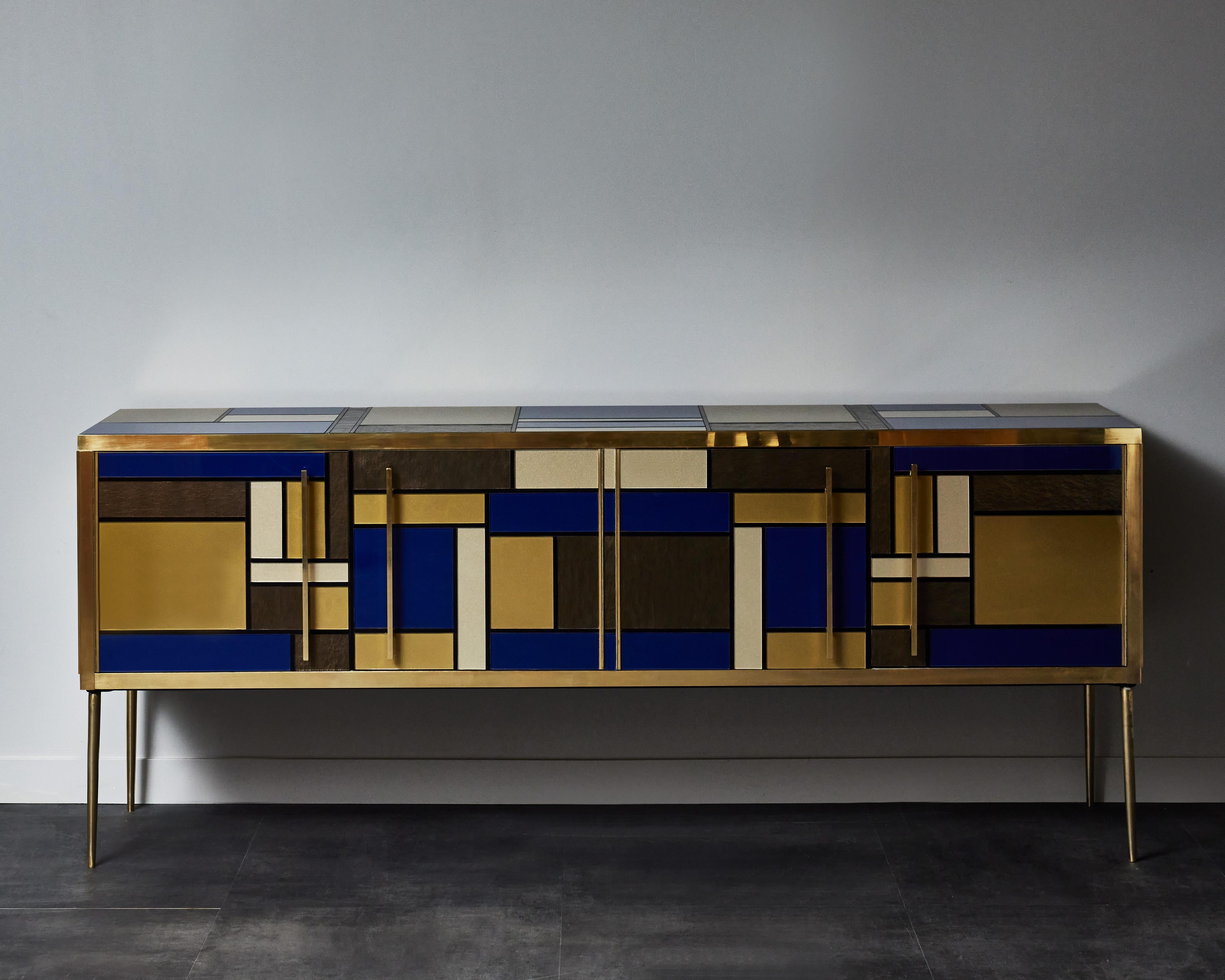 Vintage wooden sideboard with 4 doors, entirely restored and customized with tainted glasses and brass inlays, in the spirit of Mondrian.
Creation by Studio Glustin.
