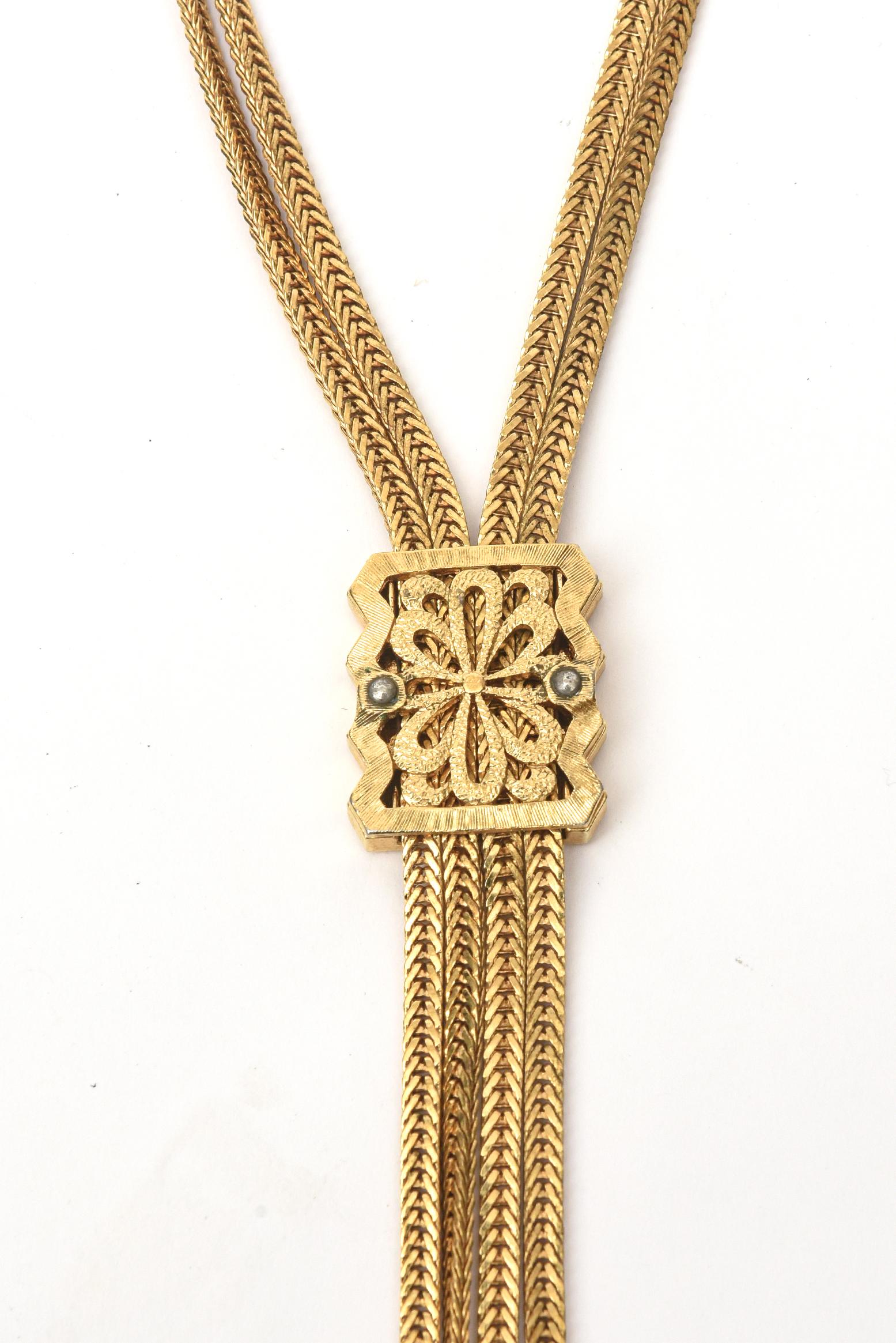 This signed Monet lariat gold filled necklace now is so chic. It is from the 60's. The chain form on each strand is elegant. The lariat medallion can go up and down to secure different placement. It has the 4 drop pendant forms at the end. It is