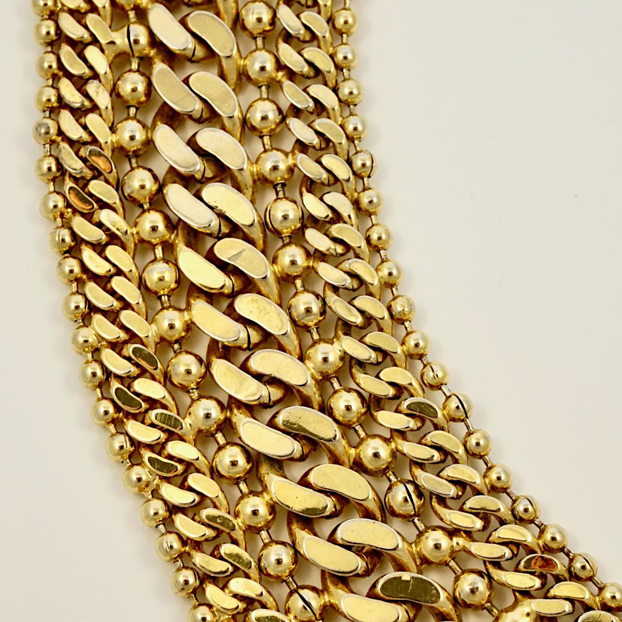 
Monet fabulous 22ct triple gold plated curb and ball link chain necklace. Measuring length approximately 50.8 cm / 20 inches by width 3.7 cm / 1.45 inch. The necklace is in very good condition. There is some wear to the gold plating.

This is a