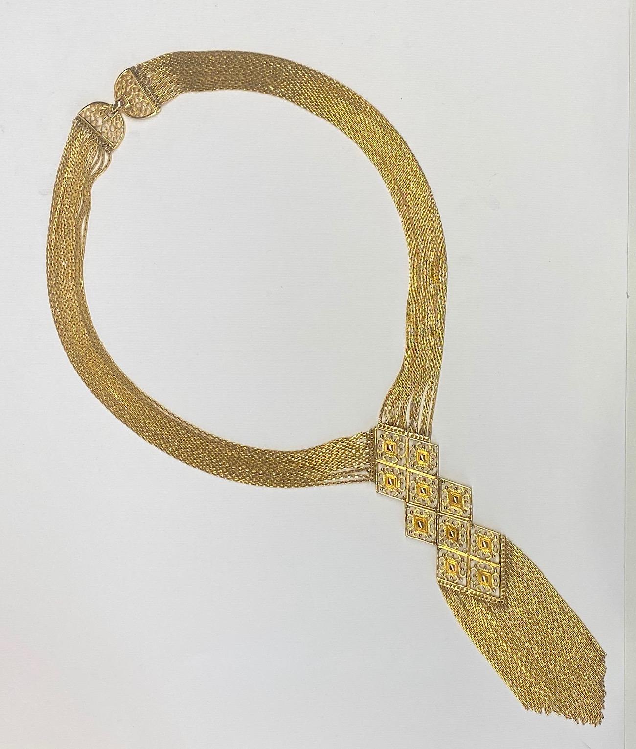 A late 1960s to early 1970s beautifully made multi strand pendant fringe necklace from the well established American fashion jewelry company Monet. The gold plate necklace is comprised of thirteen 1.5 mm wide cable links strands that support a 1.75