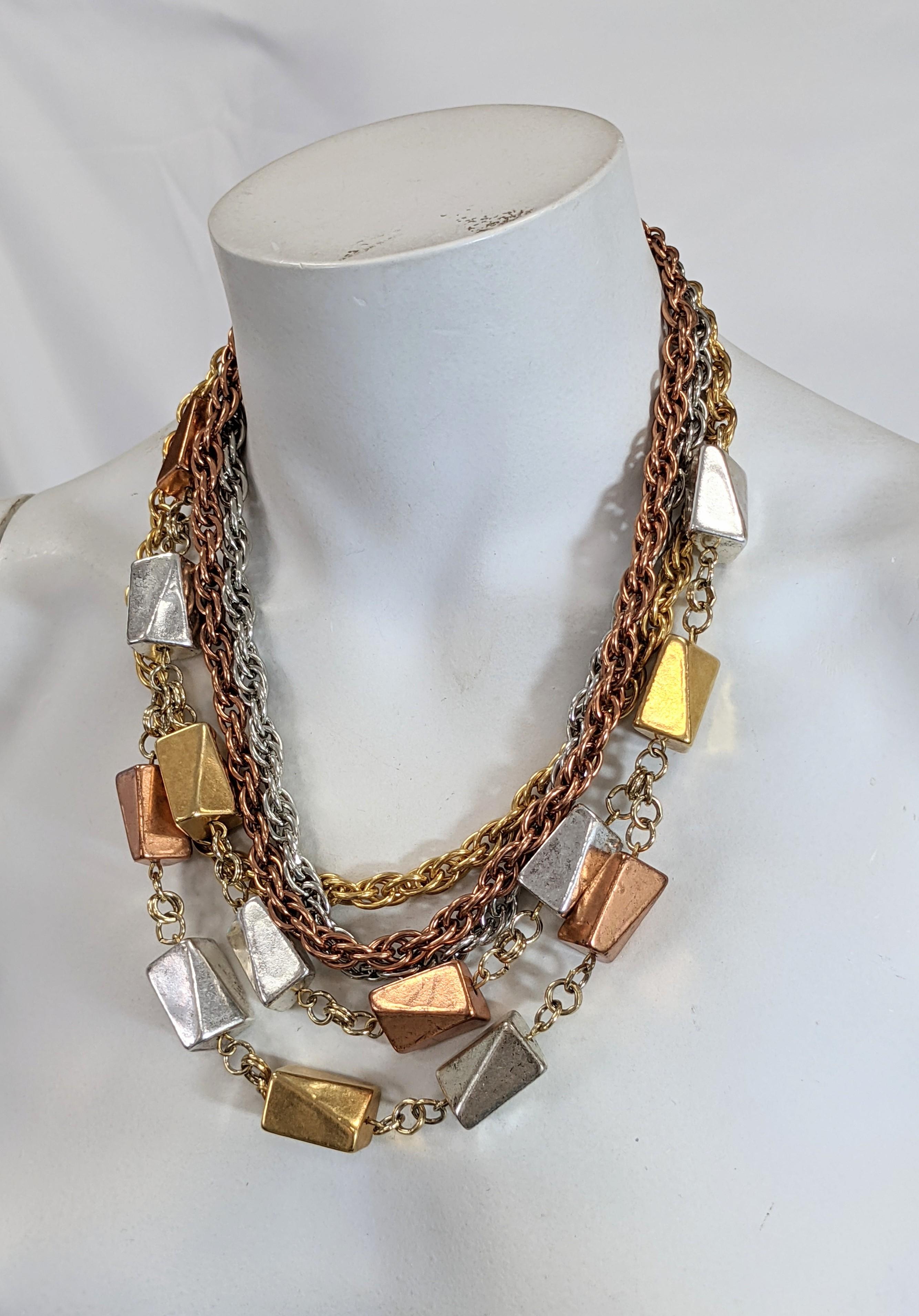 Unusual and striking Monet retro link chain necklace. The five strands of rose gold, yellow gold and silver accented with one and a half strands of cubistic rectangular metal clad bakelite resin beads of rose and yellow gold and silver plate.