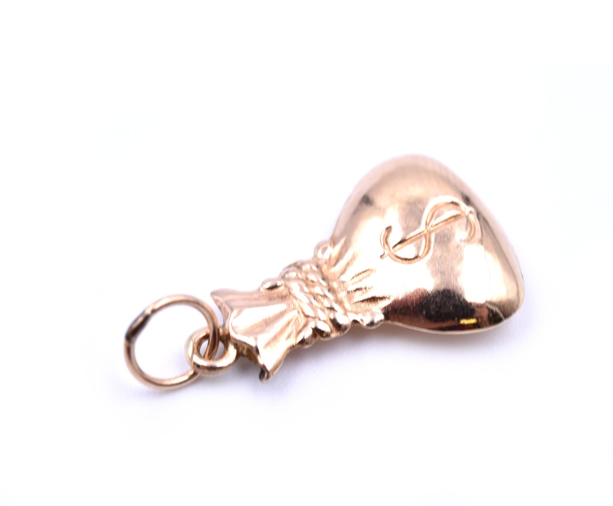 Designer: custom design
Material: 14k yellow gold
Dimensions: charm is 20mm long and 11.5mm wide
Weight: .50 grams
