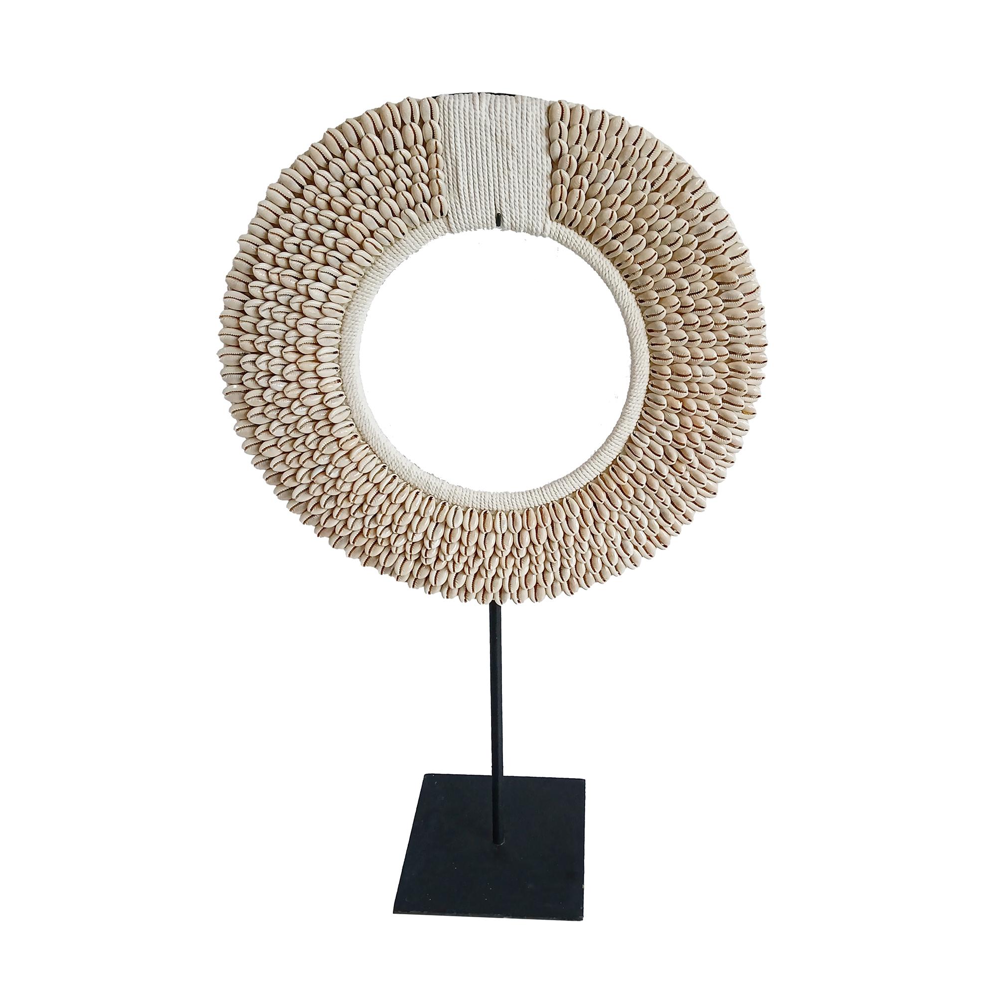 A male necklace from the Asmat Village, Papua New Guinea.

 Large Money Cowrie shells (used in earlier times as currency) seamlessly sewn in concentric rows onto a white cotton macramé base, which has been hand-knotted around a semi-circular bamboo