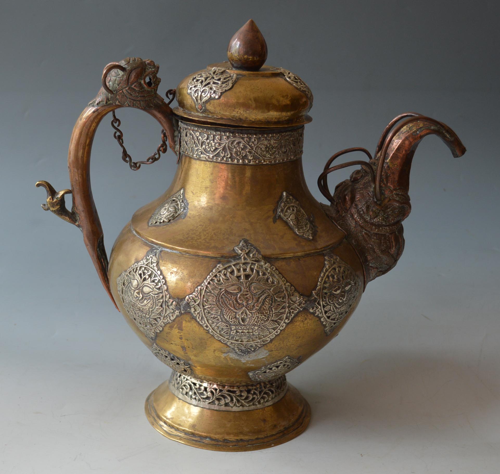 A Fine Large Antique Tibetan Tea pot
A fine rare Large handsome teapot of bulbous form Dragon handle with elephant spout crafted in brass copper with silver Buddhist medallions
H 40 cm w 38 cm Period 19th century
Condition : Good.