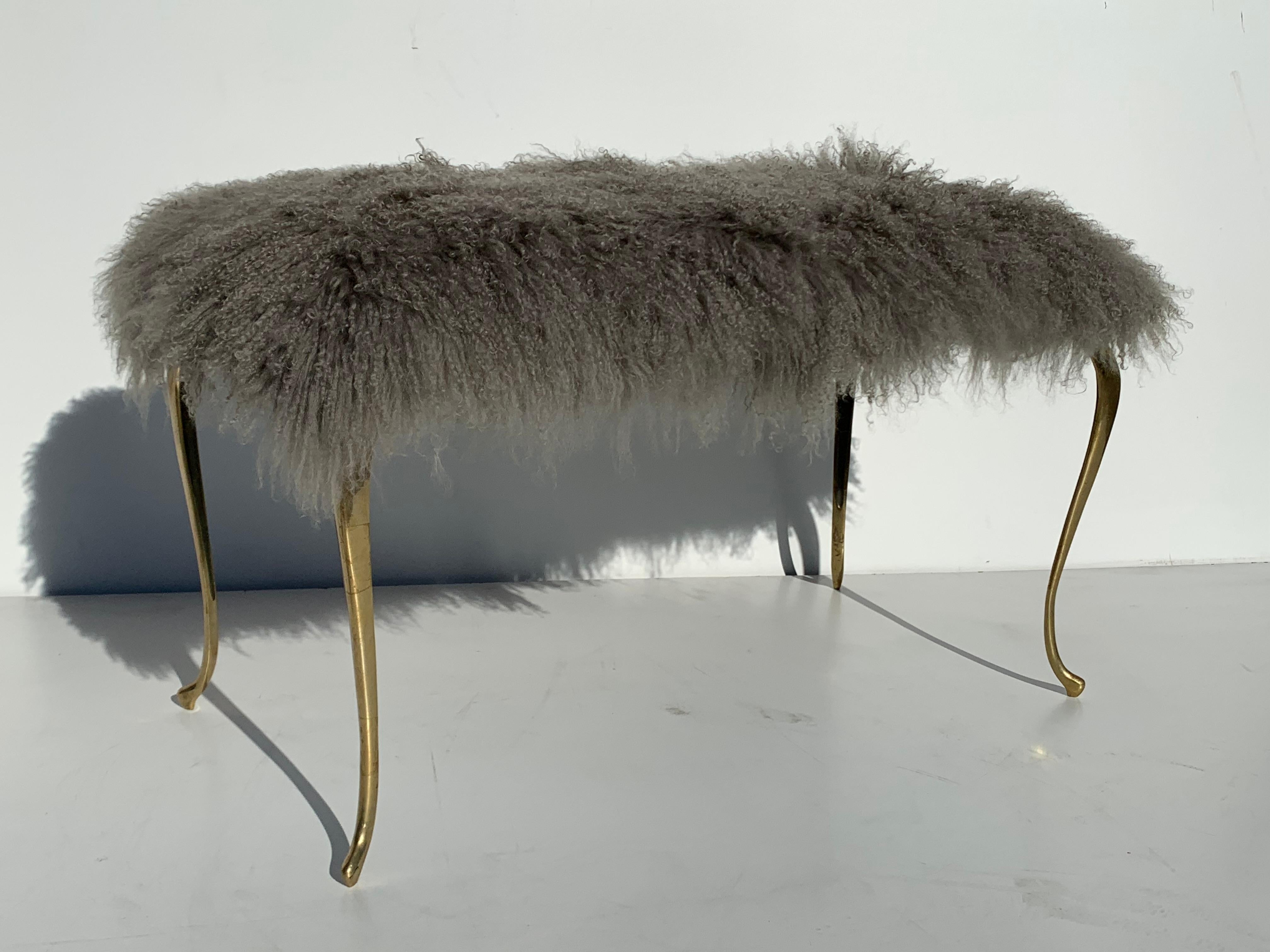 Mongolian fur bench with brass cabriolet legs.