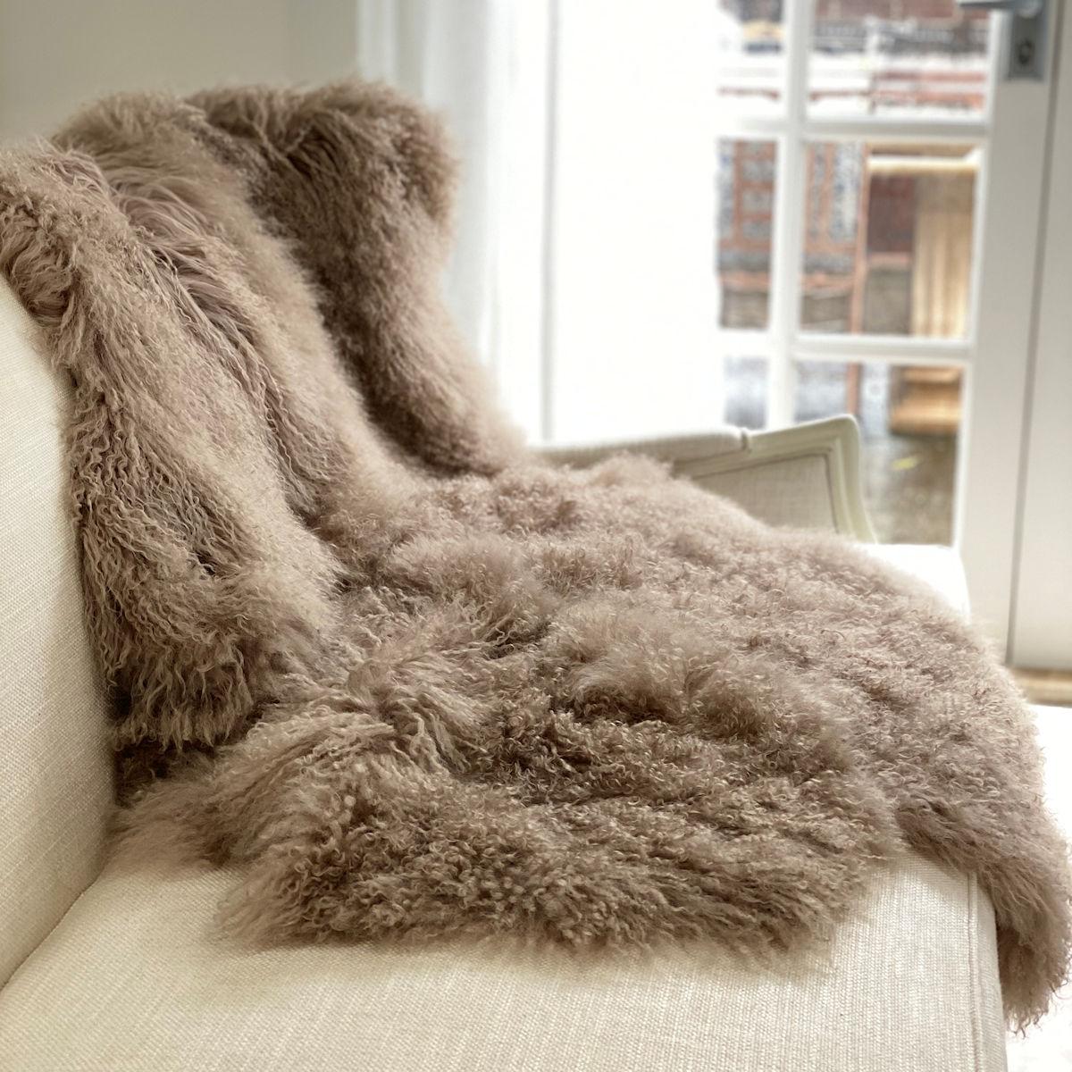 Elevate the luxury of your decor with this Mongolian Fur Throw rug. Whether styling a sofa or adding glamour to a bedroom, this exquisite fur throw will uplift the elegance and ambiance giving you the versatility in styling as as a fur throw or even