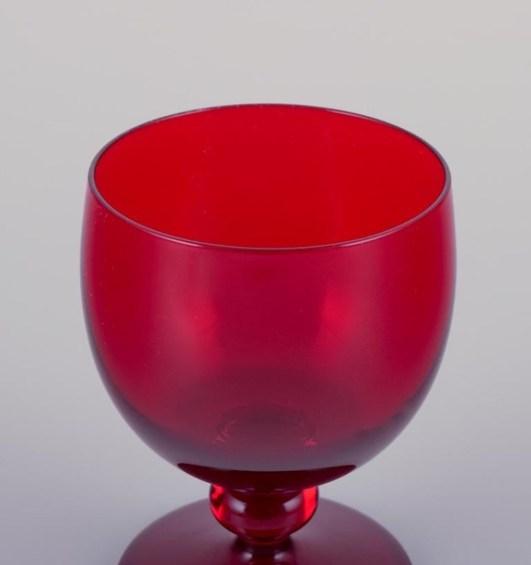 Swedish Monica Bratt for Reijmyre. Set of four small wine glasses in red art glass For Sale