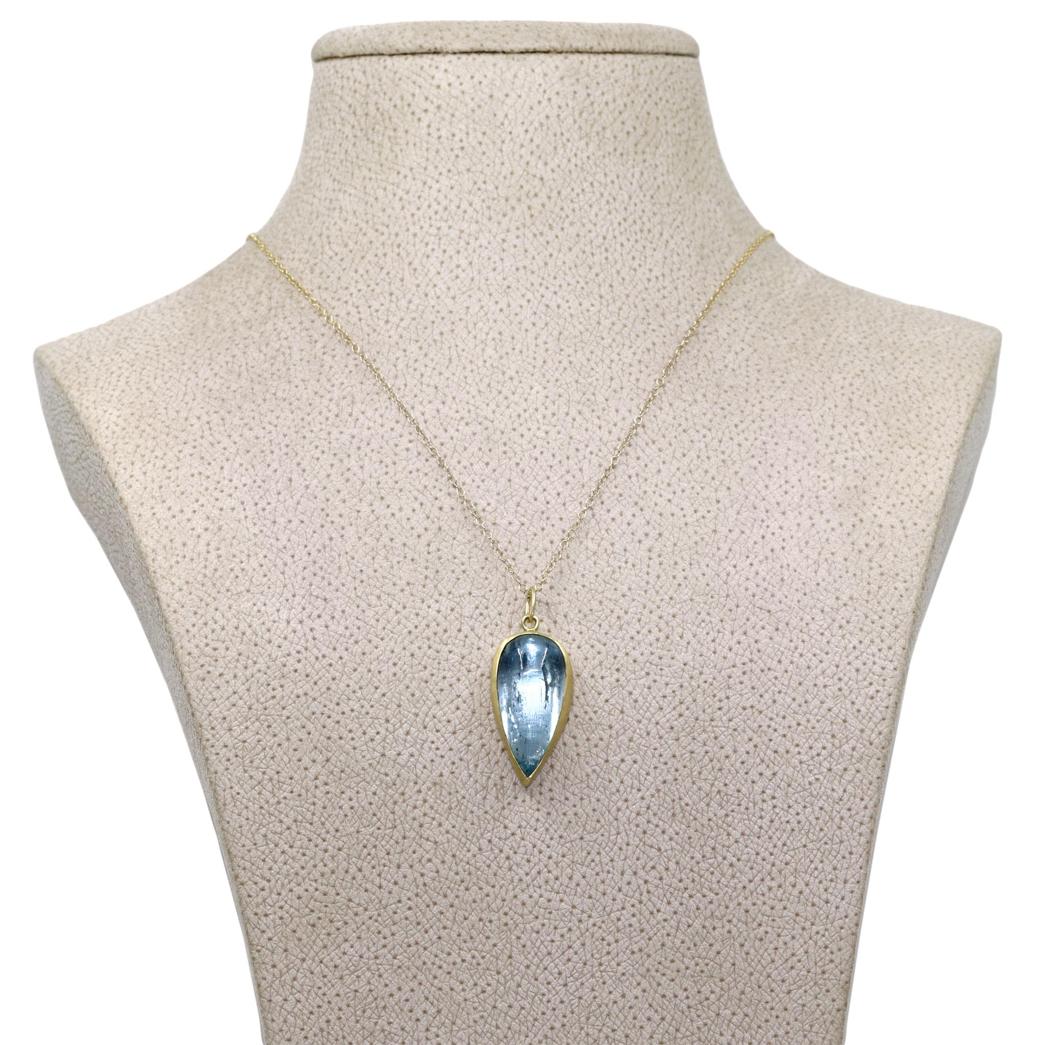 One of a Kind Drop Necklace handcrafted by jewelry maker Monica Marcella showcasing a gorgeous, three dimensional glowing aquamarine cabochon bezel-set in matte-finished 18k yellow gold on an 18 inch long 18k yellow gold chain. Total necklace length