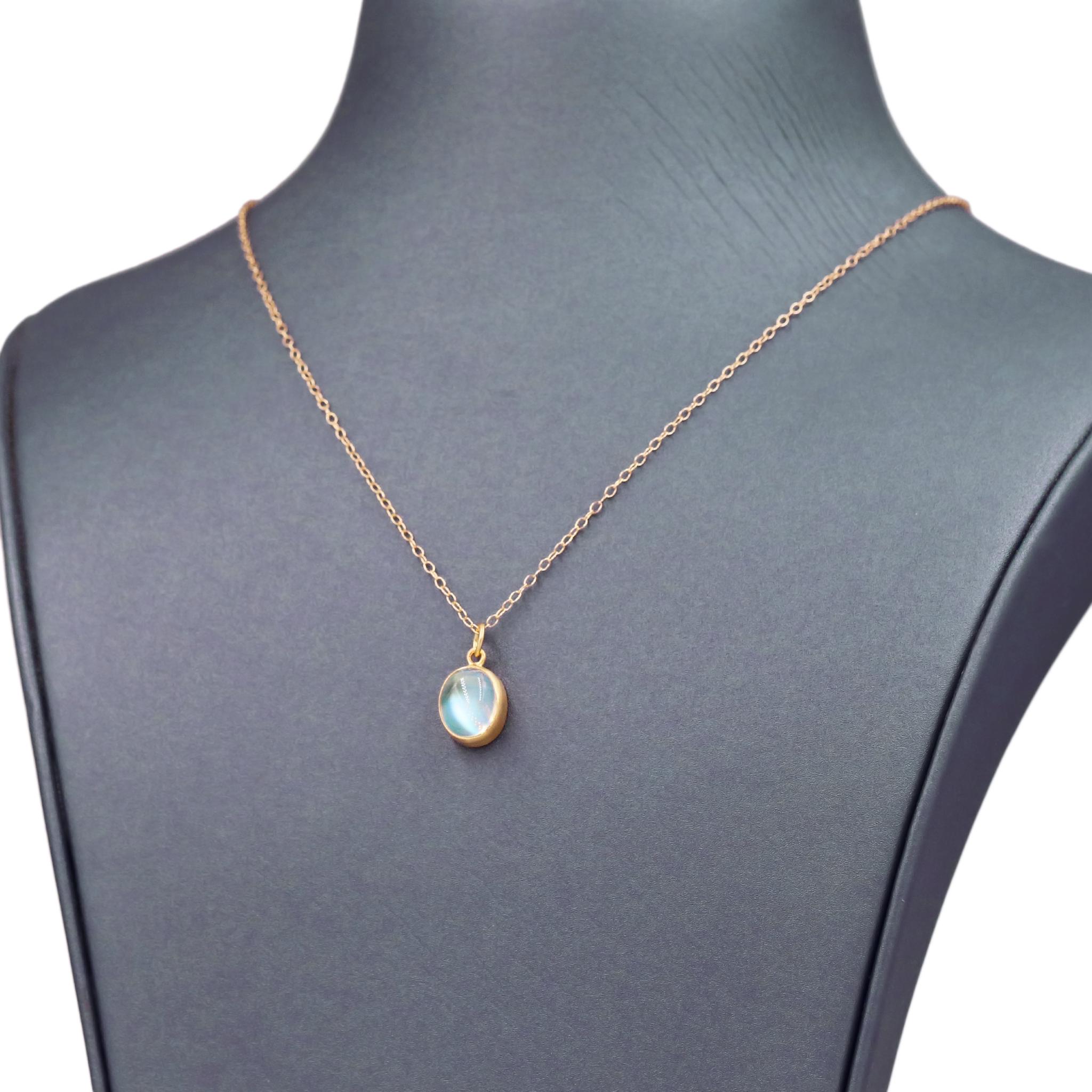 One of a Kind Drop Necklace handcrafted by jewelry maker Monica Marcella featuring a fine quality, glowing oval rainbow moonstone cabochon bezel-set in matte-finished 18k yellow gold on an 18 inch long 18k yellow gold chain. Total necklace length