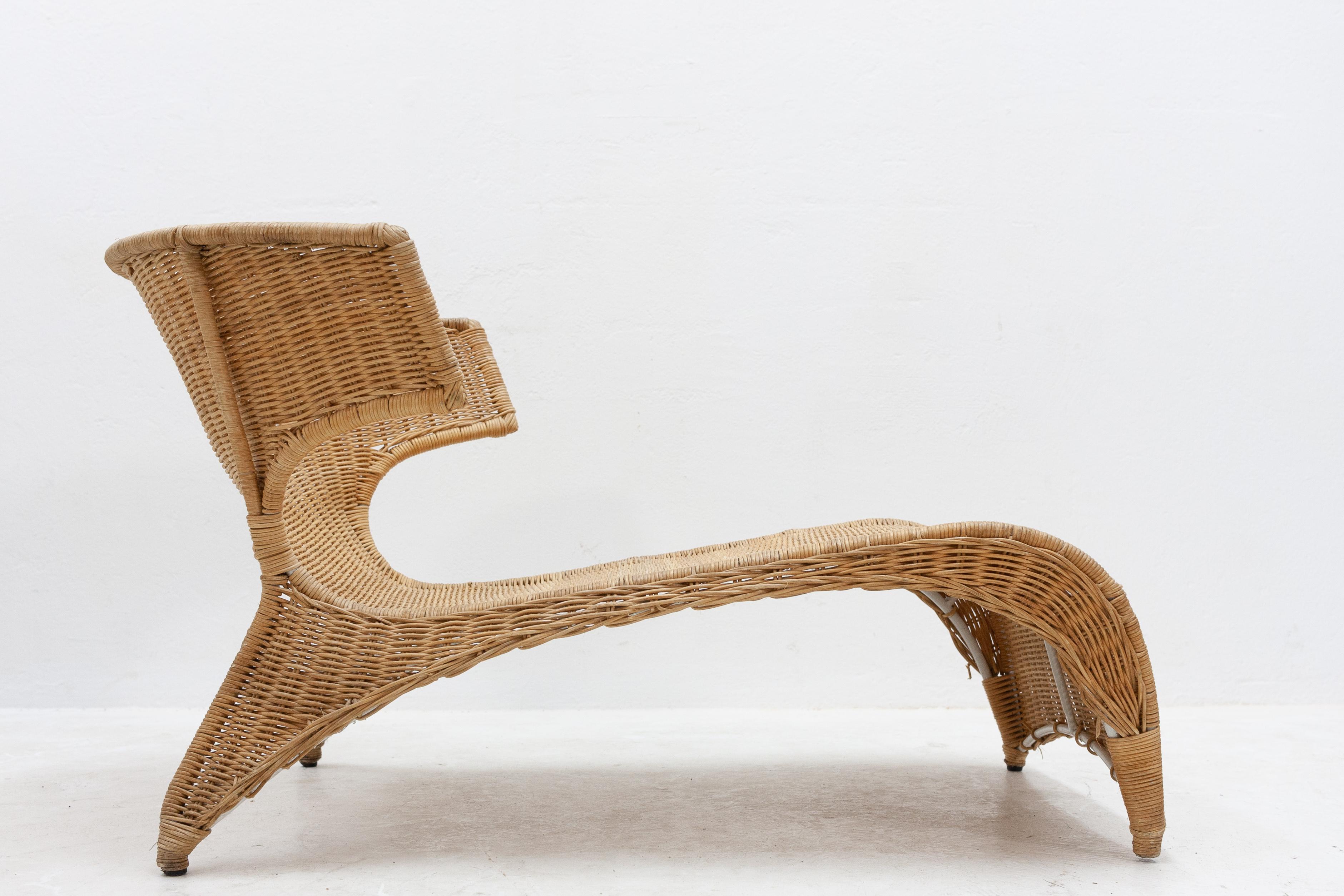 Great design by Monica Mulder. Low-slung lounge chair in natural rattan, with the original seat cushion.