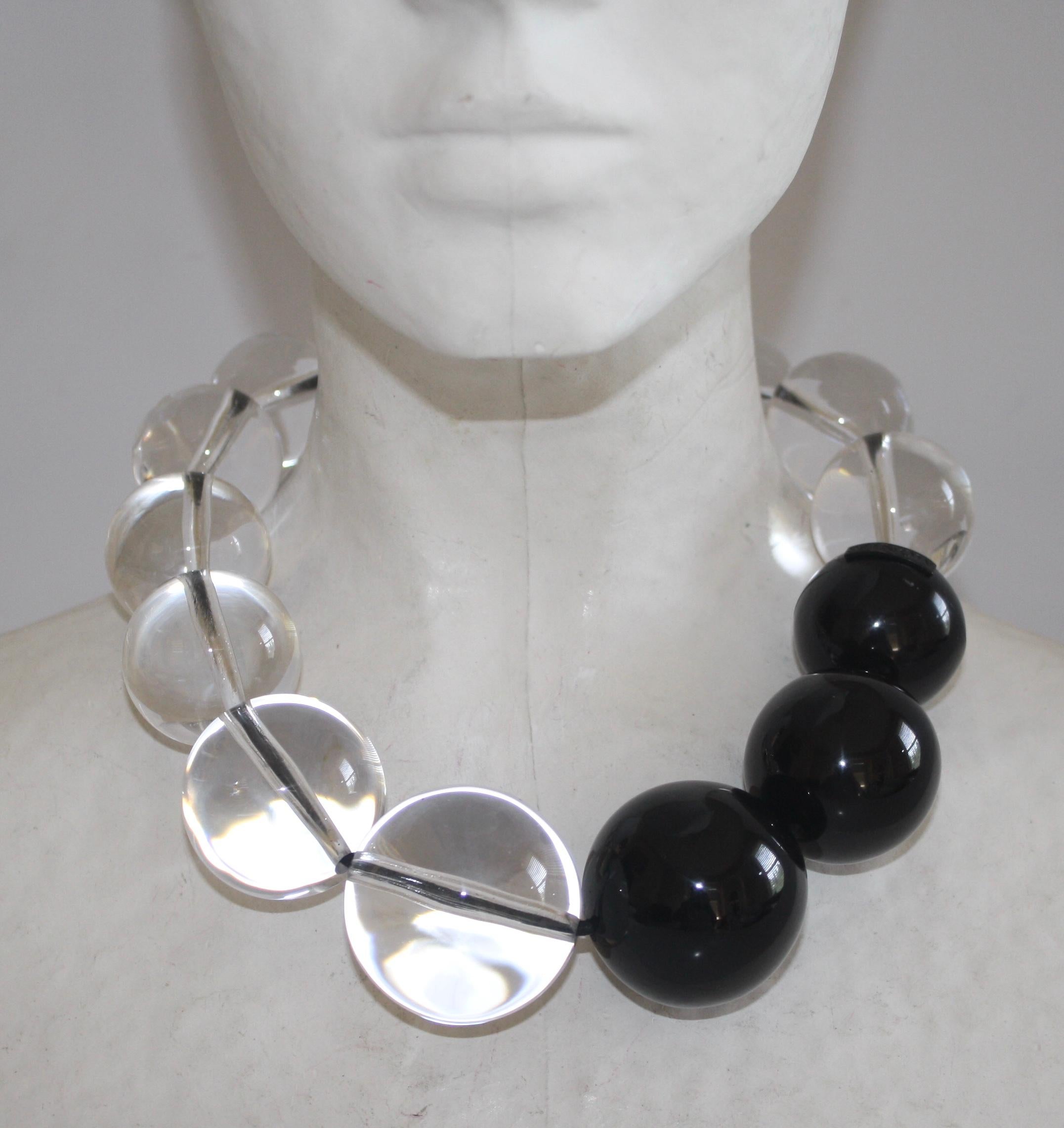 Monies Acrylic, Polyester, and Leather Necklace with magnetic closure. 