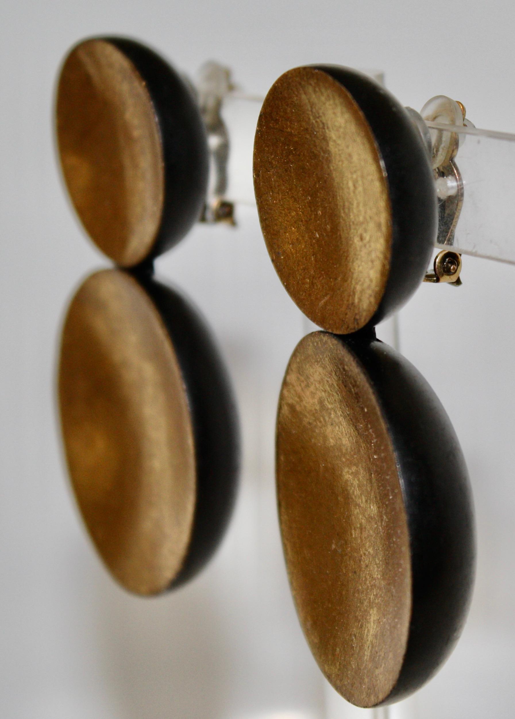 Kamagong and Goldfoil clip earrings . Oversized , yet very light , you will enjoy wearing these all day.
