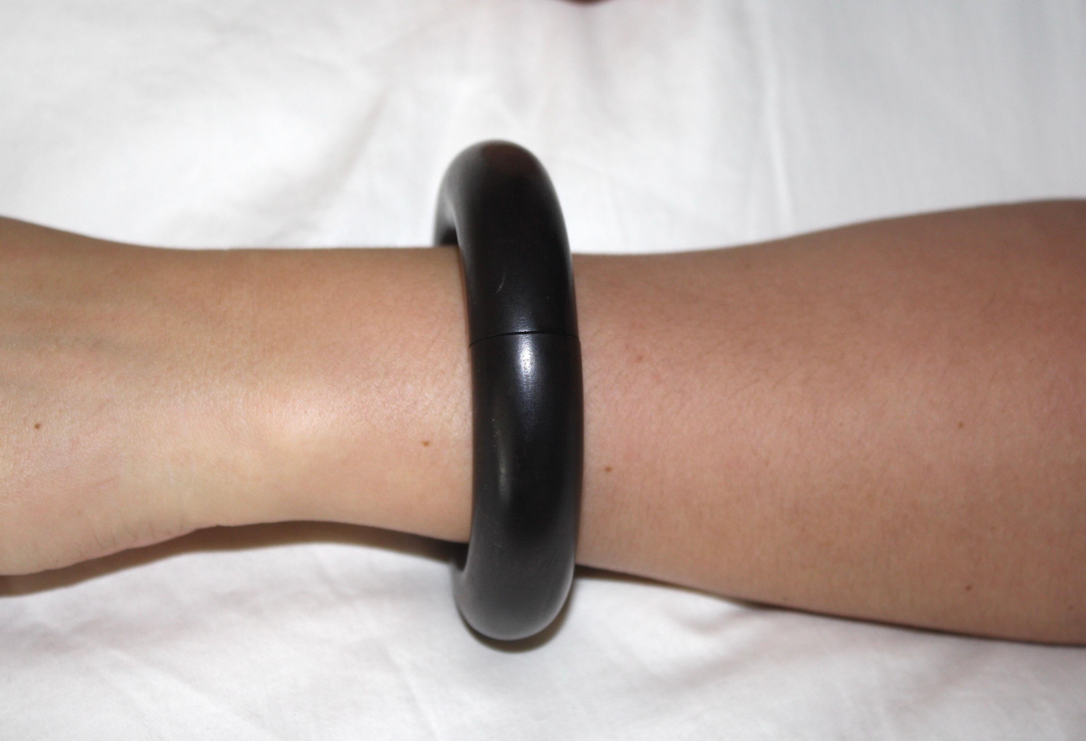 Ebony wood statement bangle with elastic interior allowing for fit on all hand sizes. Made by Monies, Denmark. 
