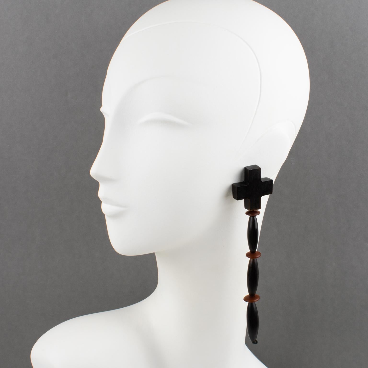 Beautiful oversized clip-on earrings designed by Gerda Lyngaard for Monies. Extra-long dangling geometric shape, with smooth hand-carved resin beads, carved and treated to resemble faux-black-horn and exotic wood elements. Marked 