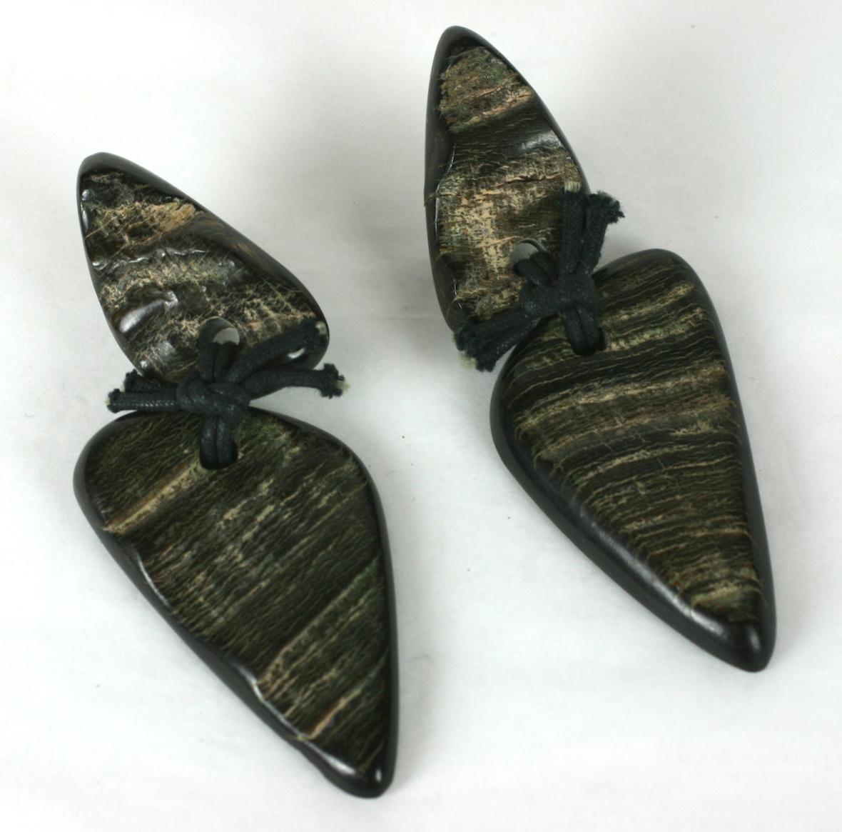 Monies Faux Horn Carved Statement Earrings. Resin is carved and treated to resemble faux horn and black waxed cord is used to attach the earring pendant to each top. Very lightweight and wearable.
1980's. Clip back fittings. Signed. Monies, Gerda