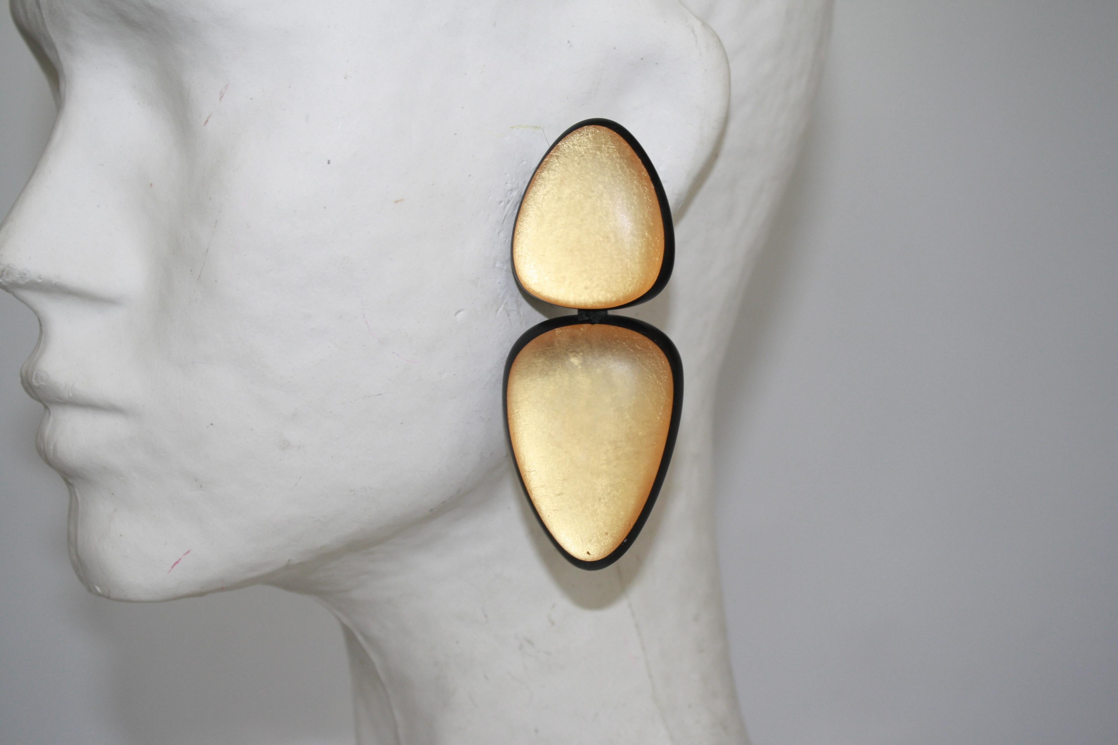 Gold acrylic clip earrings from Monies Denmark. 