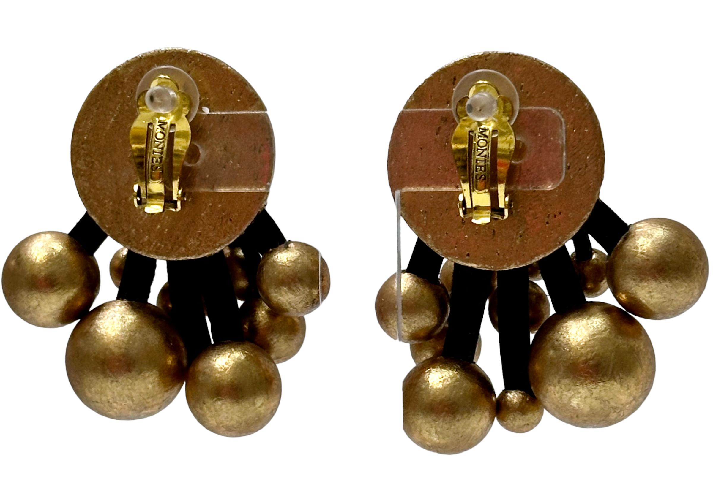 Acacia wood and gold foil. Drops are attached with black leather. Clip earrings. Looks perfect with Monies Gold foil large beads Chocker 
MONIES IS A DANISH JEWELRY  COMPANY FOUNDED IN 1973 BY GERDA AND NIKOLAI MONIES. ALTHOUGH BOTH ARE CLASSICALLY