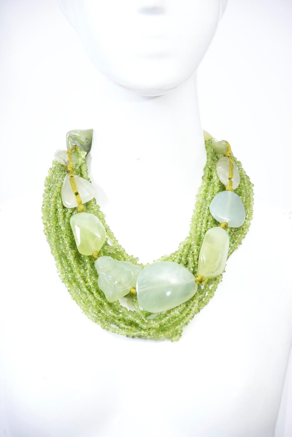 Monies is a Danish company known for its exuberant and bold costume jewelry, most made out of natural materials. This necklace, from the 1990s or early 2000s, is composed of 18 strands of small aventurine beads overlaid with a silk-strung strand of