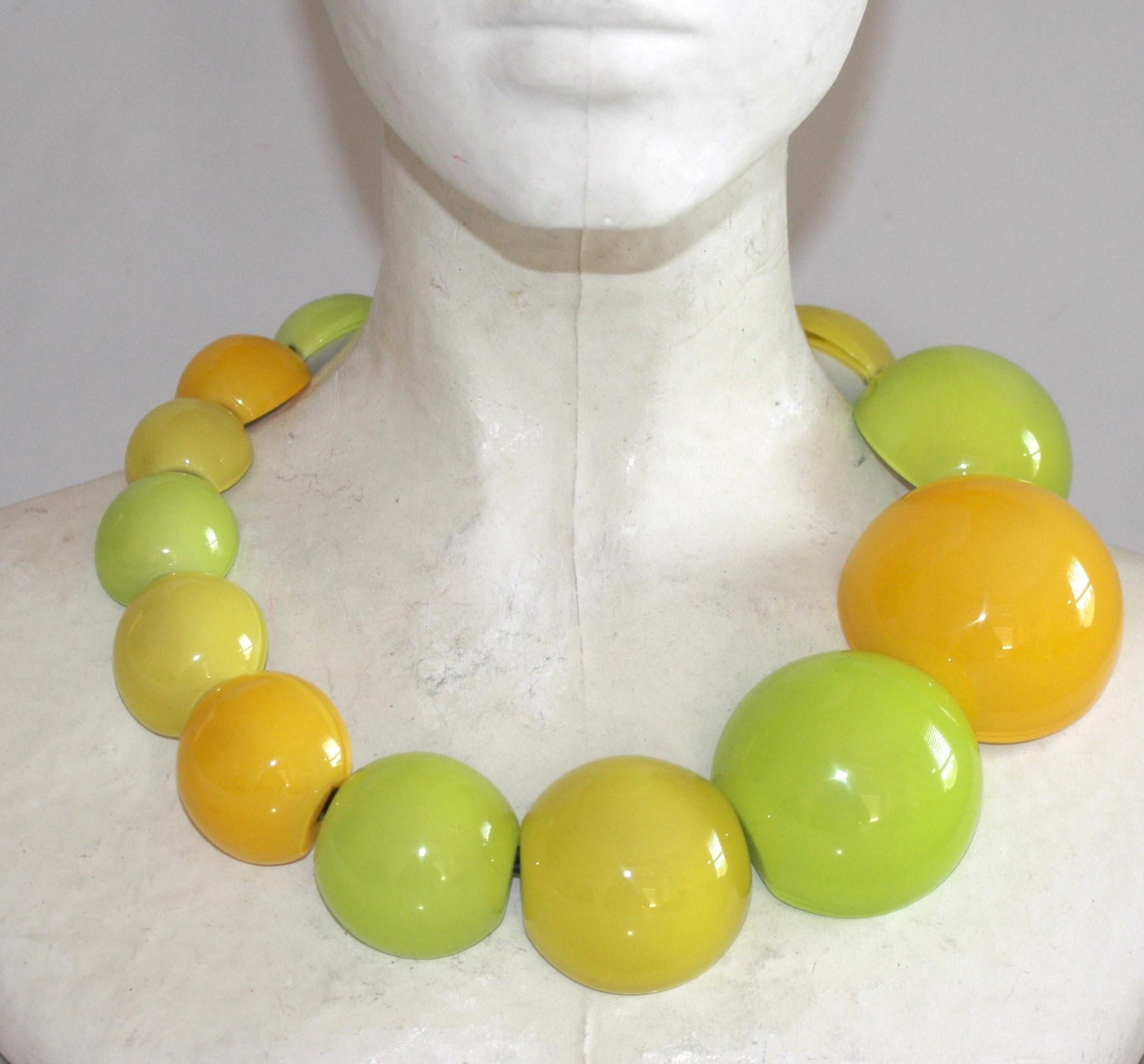 Polyester ball shaped necklace in green, yellow, and orange from Monies Denmark. 