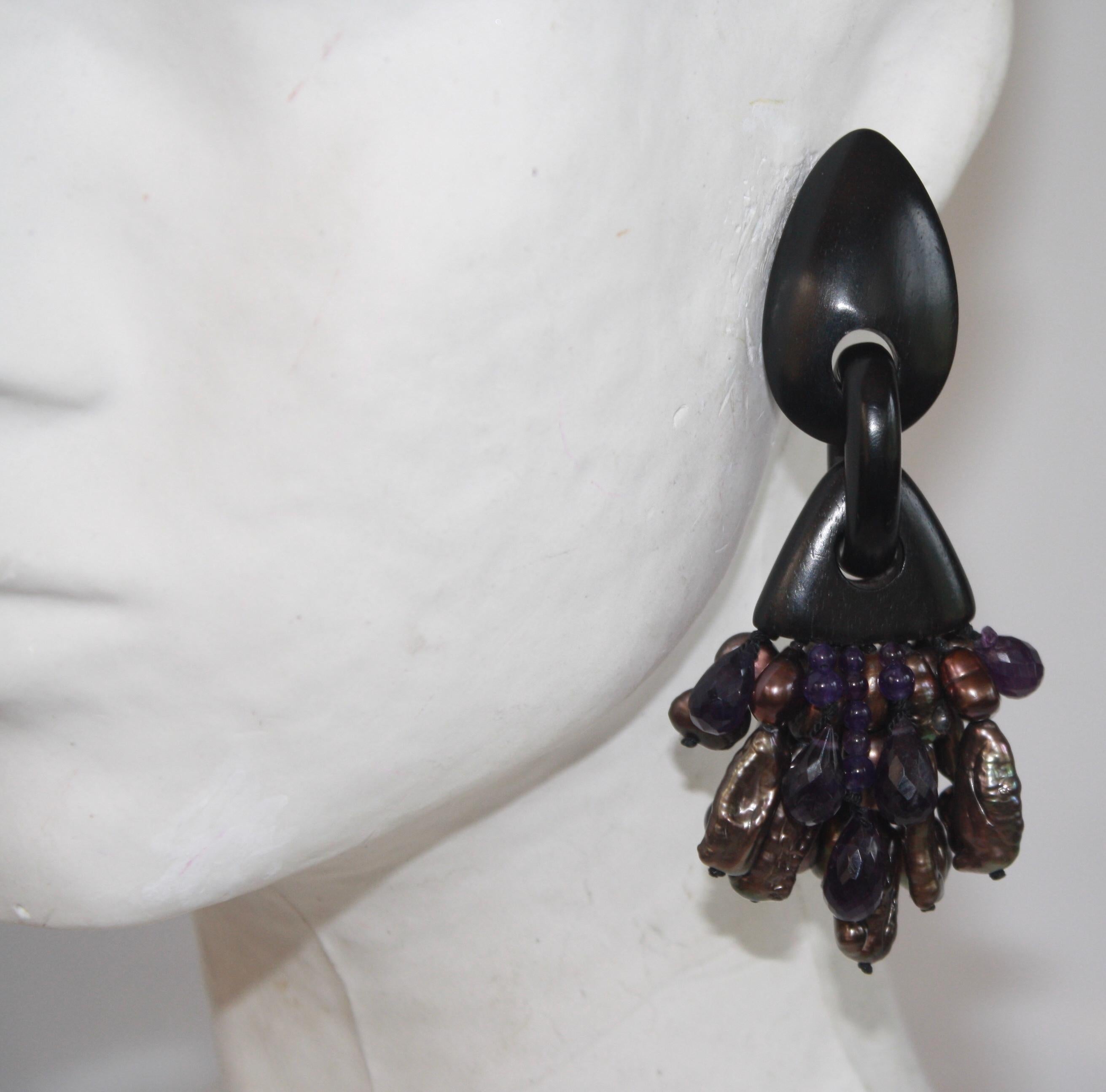 Baroque pearl, amethyst, and ebony wood one of a kind clip earrings from Monies Denmark. 