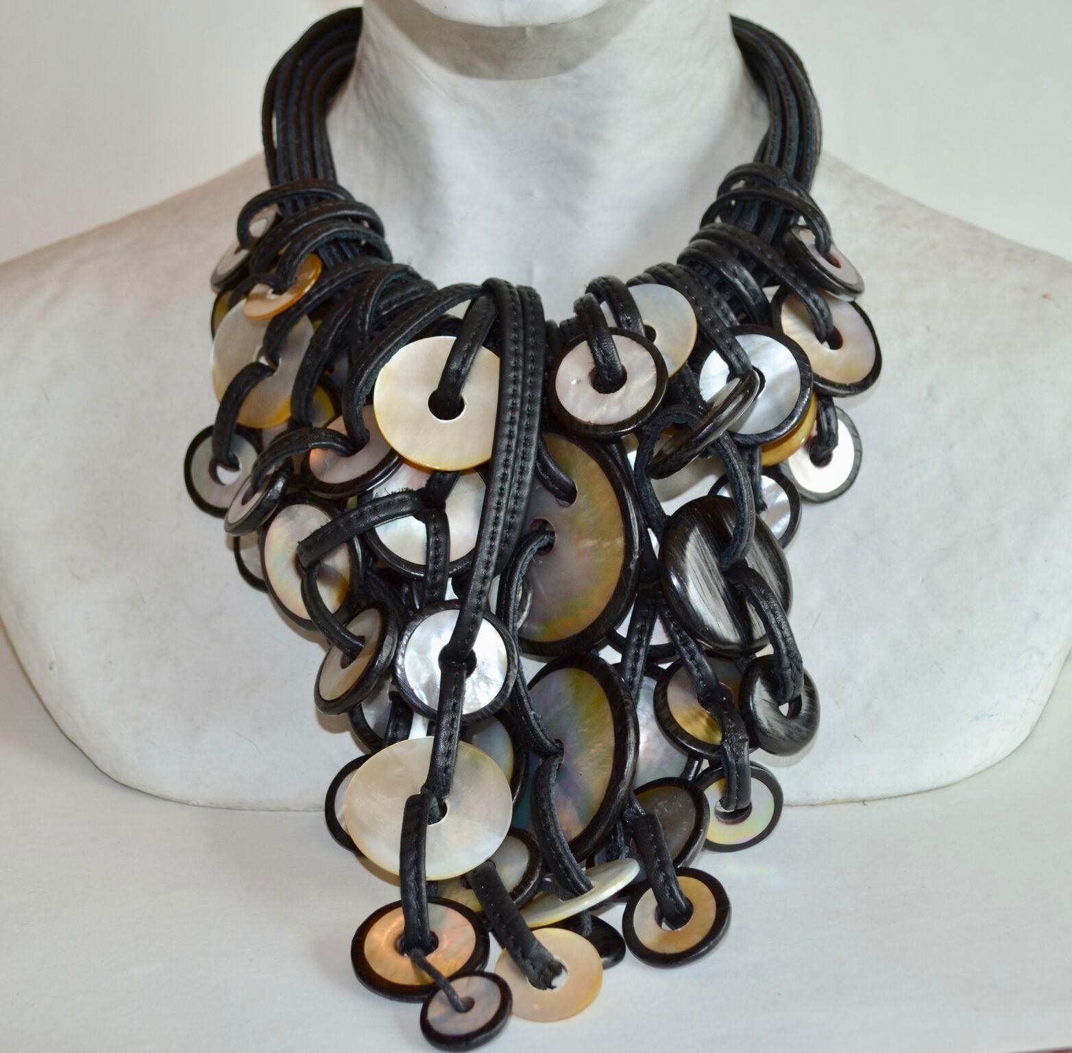 Statement piece from Monies - one of a kind. Made with mother of pearl, ebony wood and leather. 

Length of longest pendant 8”