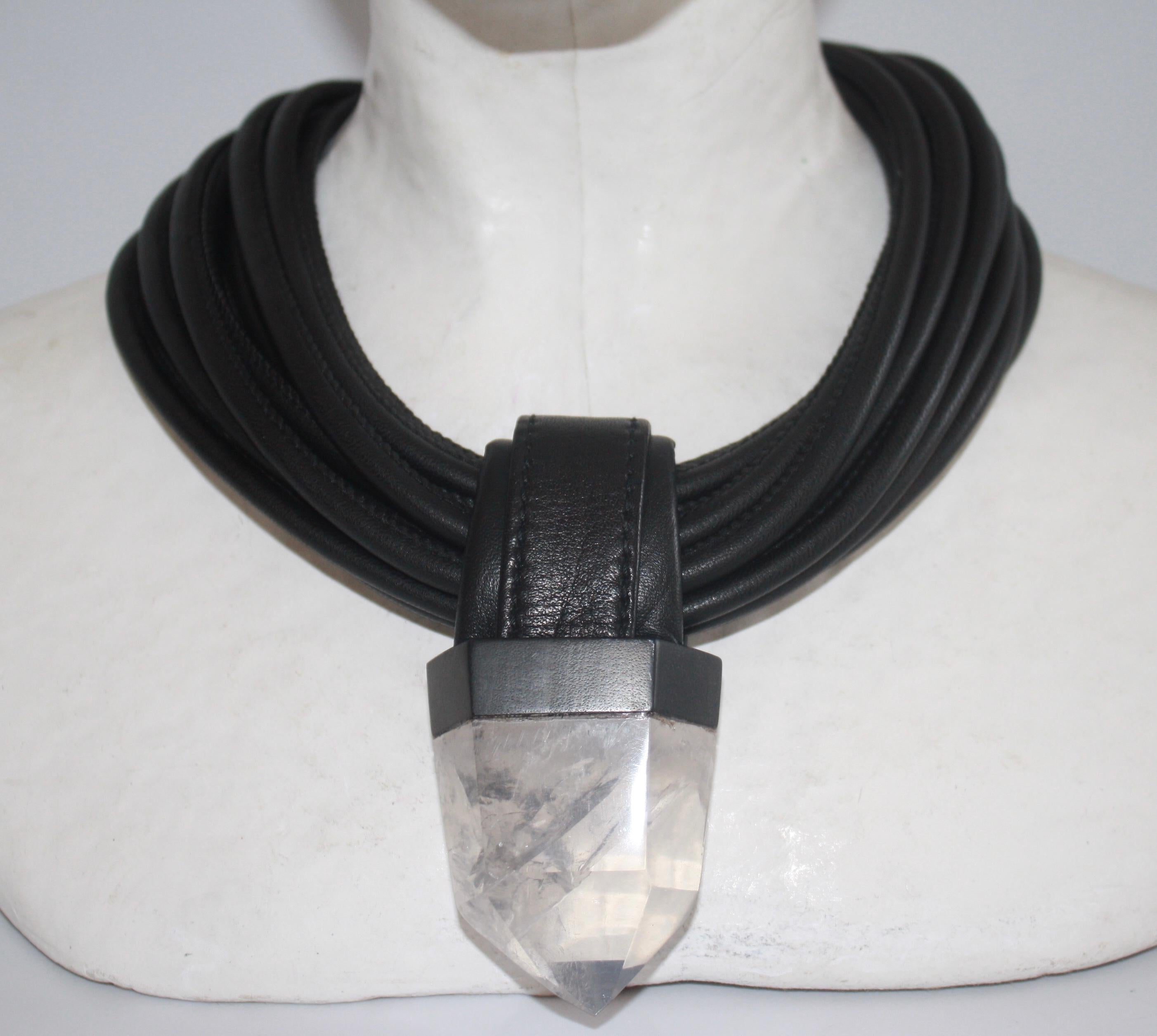 Multi strand leather choker necklace with oversized quartz pendant set in ebony wood from Monies Denmark. Stone is 2.5” long x 1.5” wide and there are 13 strands of leather. 