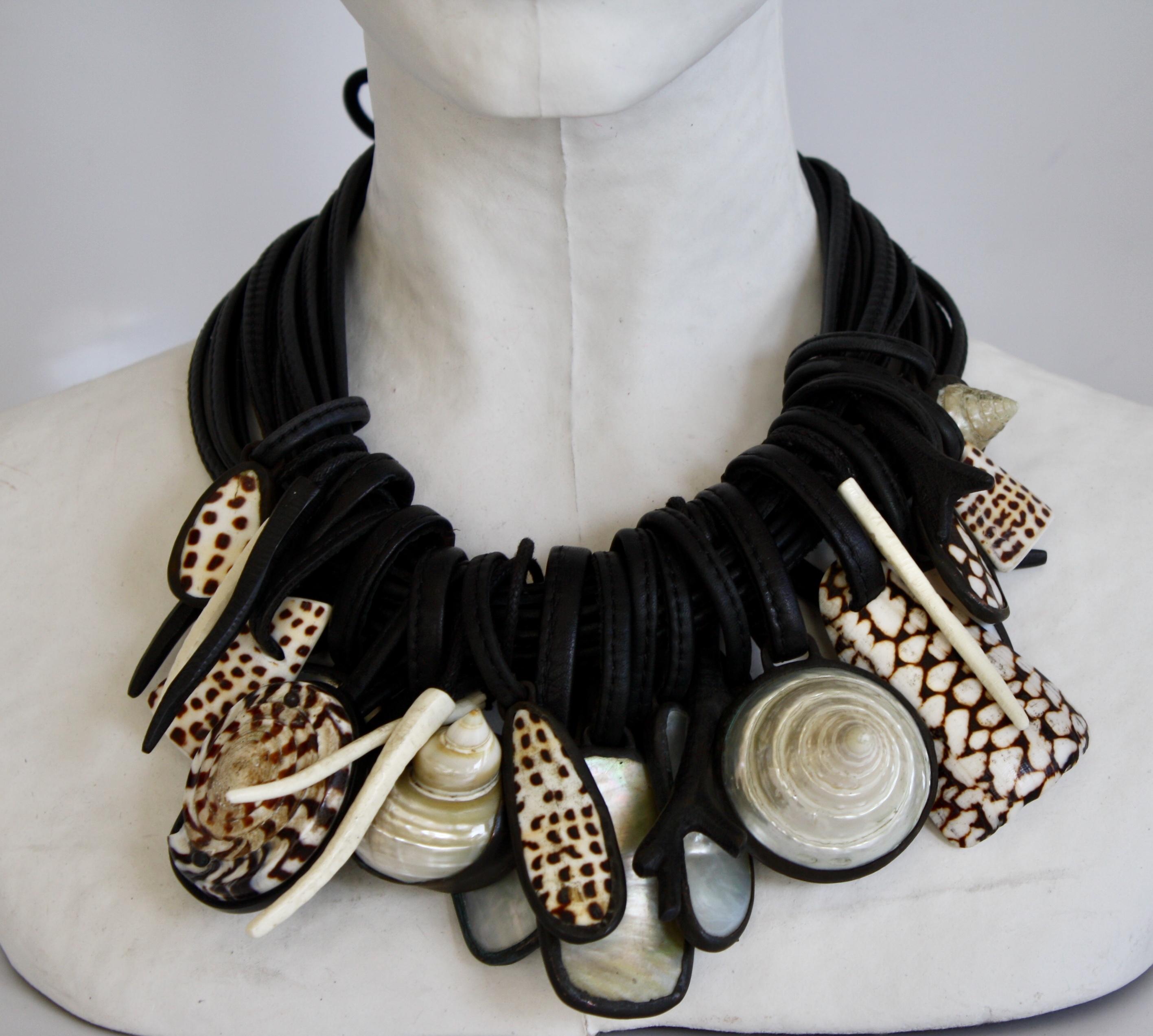 Shell, mother of pearl, rock crystal, and ebony multi pendant necklace on 11 strands of leather from Monies Denmark. 