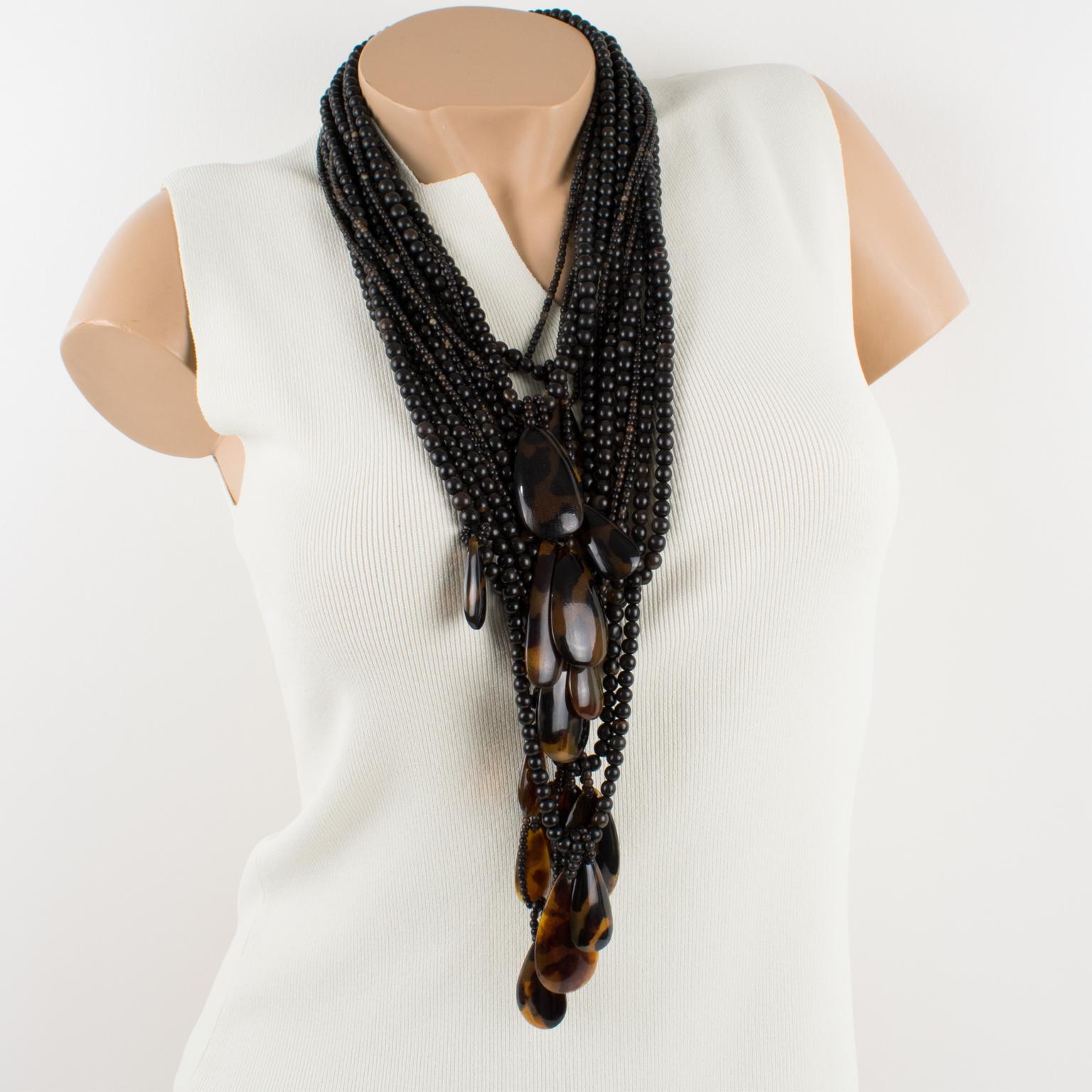 Mesmerizing oversized resin necklace by Gerda Lyngaard for Monies. Chunky hand-crafted multi-strand carved seed beads in resin carved and treated to resemble faux horn, complemented with tear-drop resin elements in faux tortoise marble color. Resin