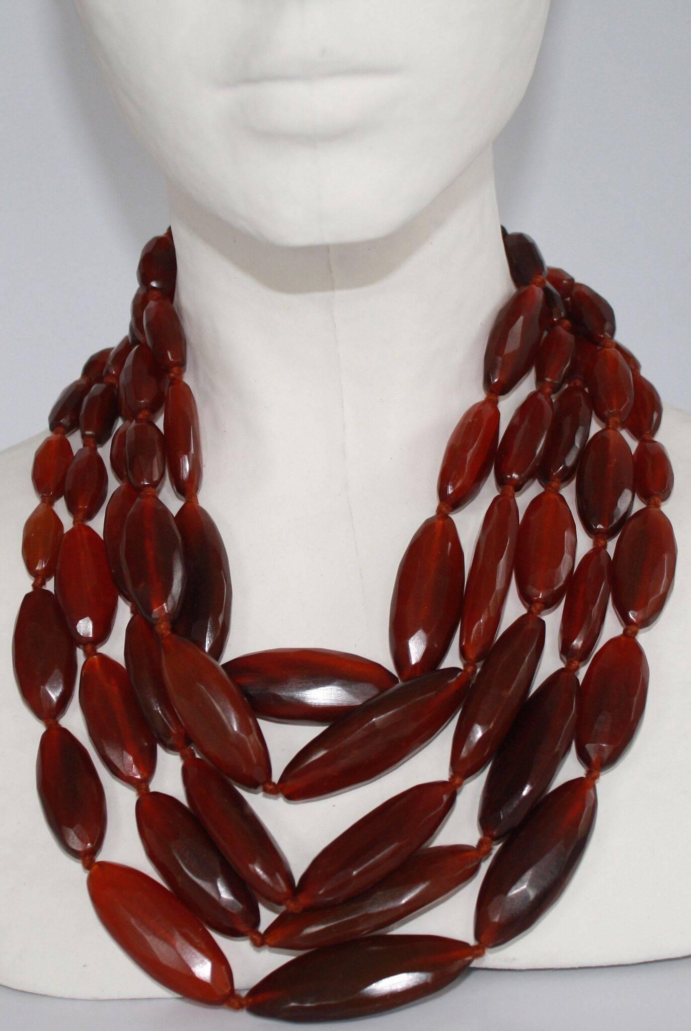 Five strand necklace from Danish designer Monies. Made with red horn. Lightweight and smooth on the skin. 