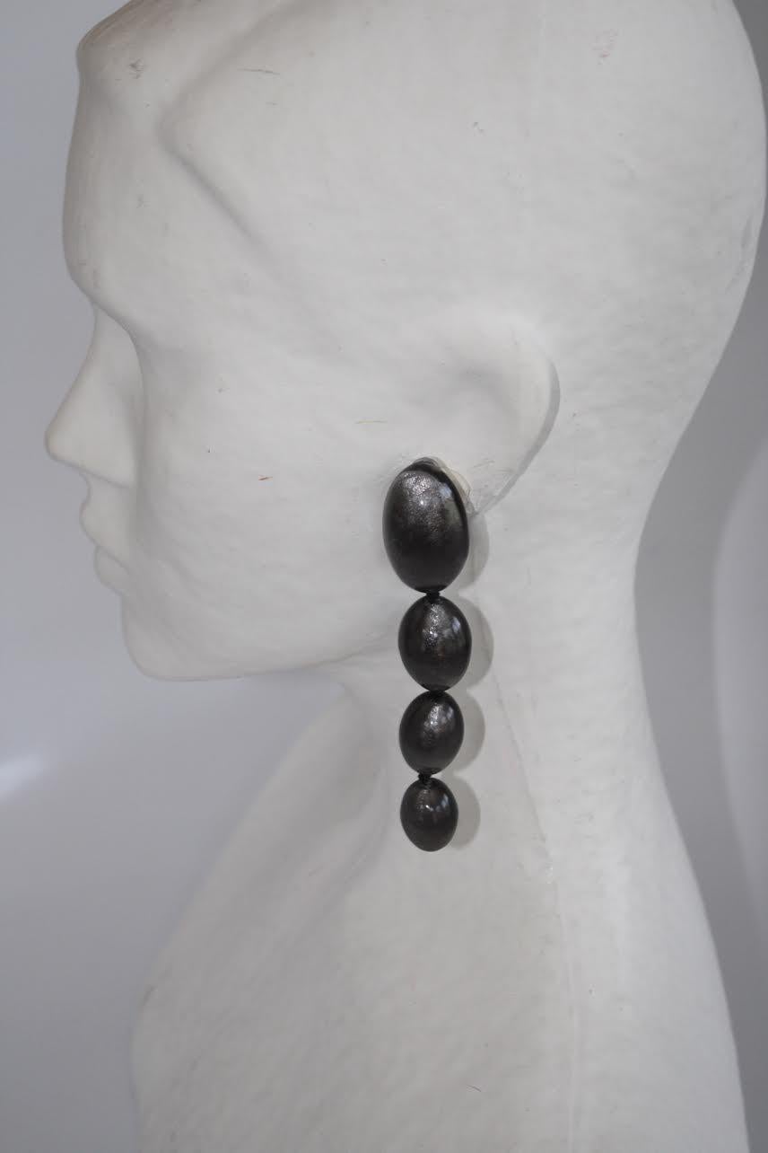 Handmade in Denmark, these long silver leaf in polyester clip earrings are chic and extremely lightweight. 