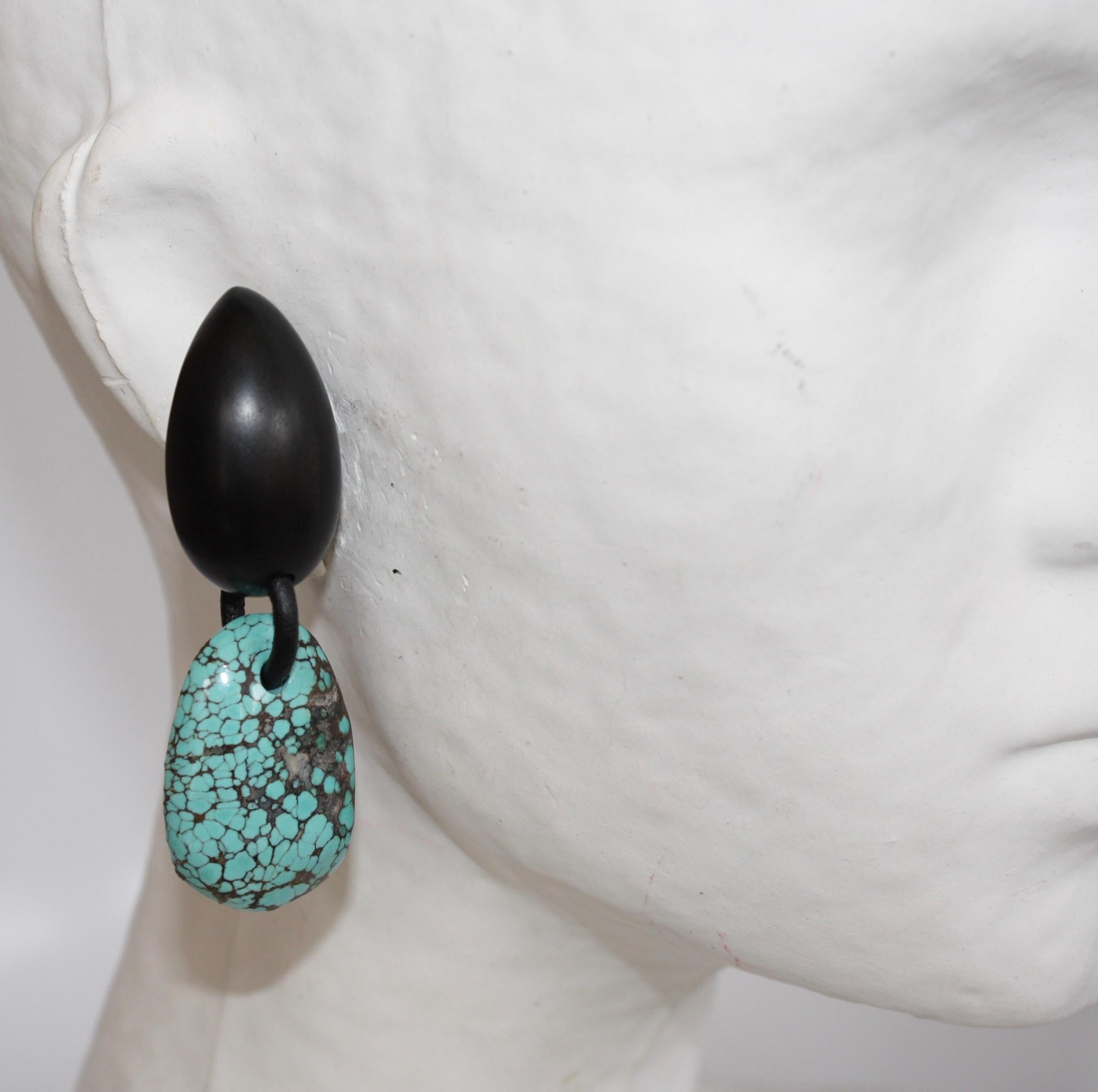 Unique turquoise drops hang from carved ebony wood clips in these gorgeous earrings from Monies Denmark. 
