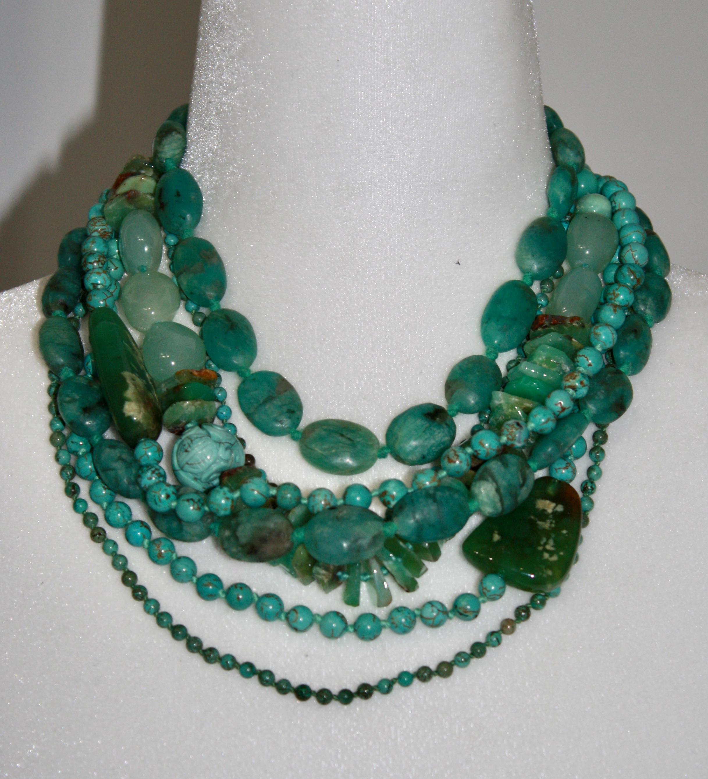 7 strands of semi precious stones in shades of green create this unique creation by Monies. Another example of their exceptional work.