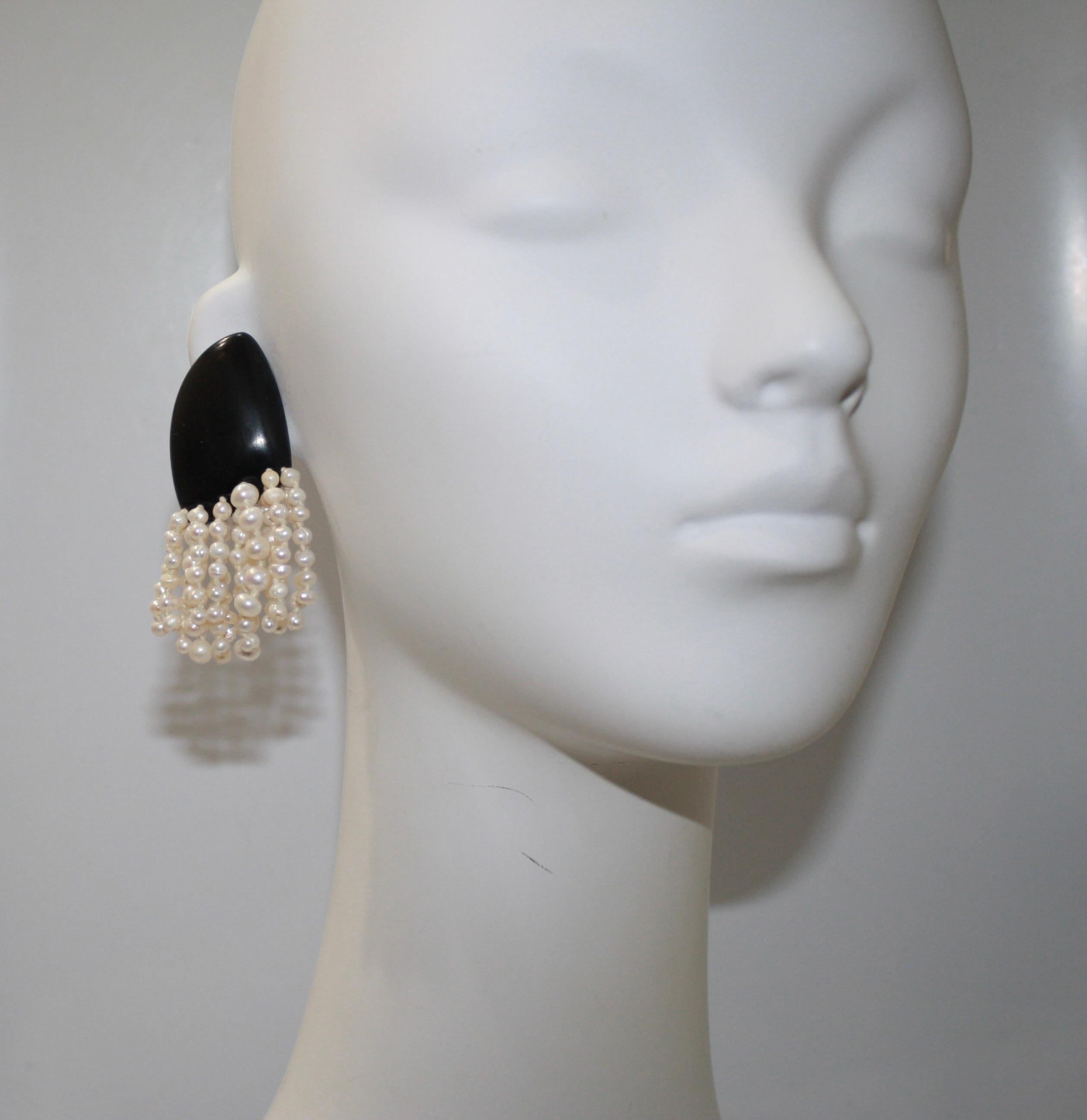 16 short strands of freshwater pearls knotted. Ebony clip
