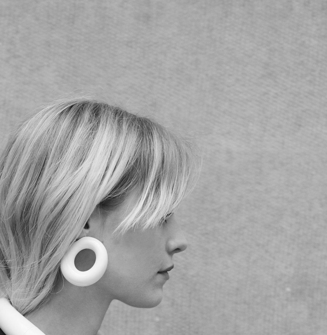 Modern and chic white loop earrings from Monies Denmark. 