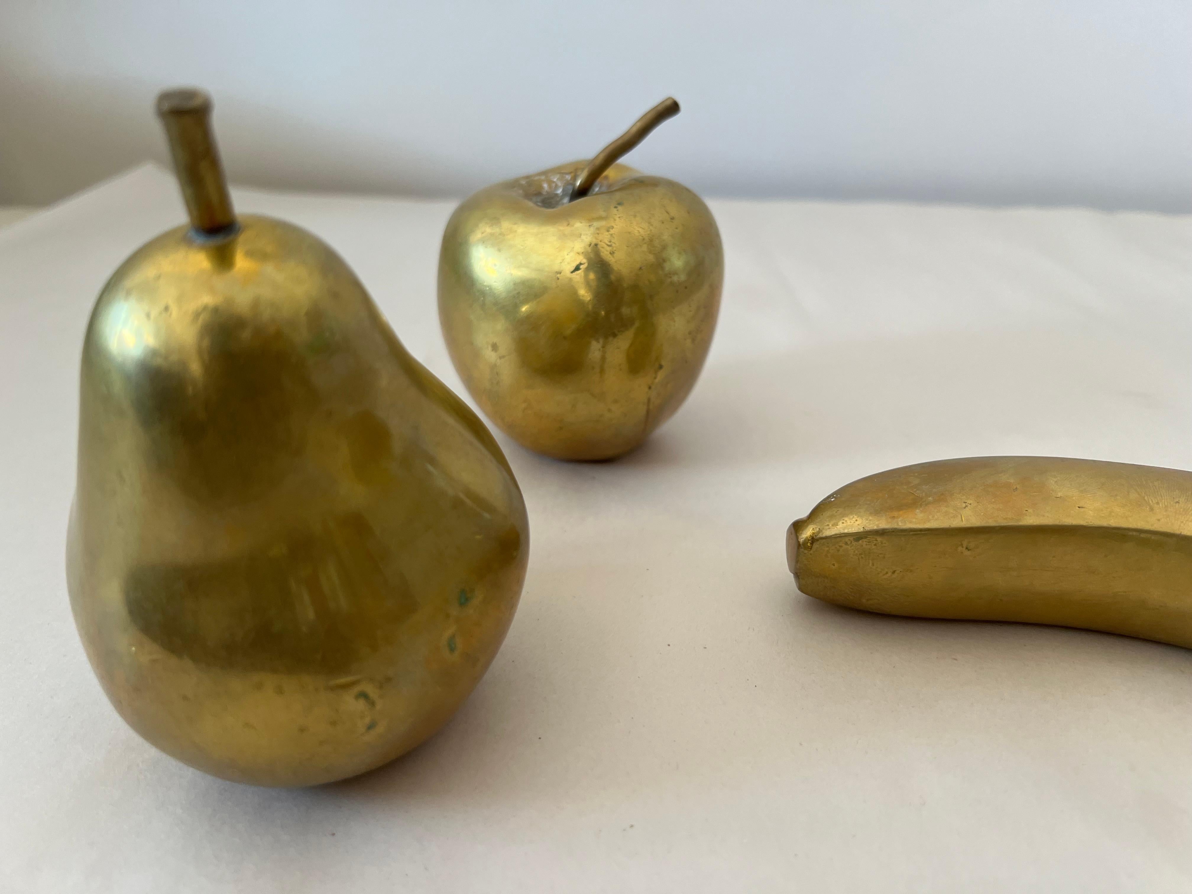 A group of three fruit sculptures by Monique Gerber, French sculptor, ca' 1970's. Done is solid patinated bronze. Each one signed with engraving.