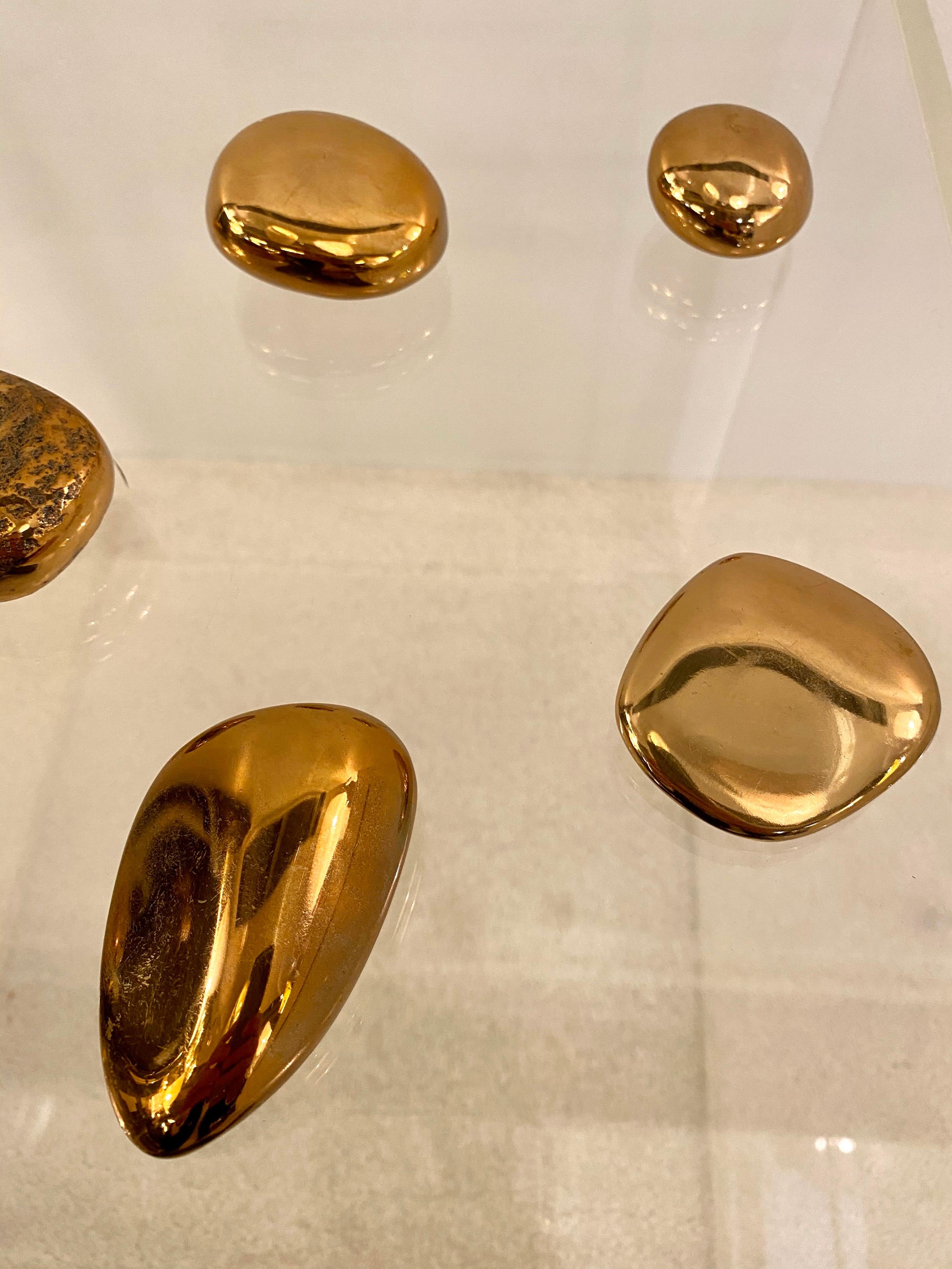 These seven solid bronze Peebles have been created by French sculptor, Monique Gerber in 1970.
This gift of the sea (as she called them!) can be useful as paperweights or be displayed on a table for decoration.
Smooth, heavy, brush gold finished,
