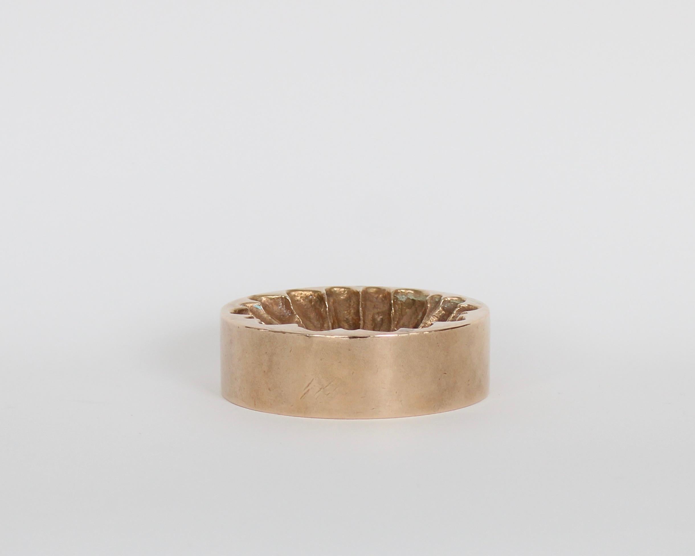 A bronze vide poche or decorative dish by French artist Monique Gerber in the motif of a daisy or Marguerite. This bottom of this vide poche once had felt on the bottom which has left a patina. 
Also the signature is much larger and unique.