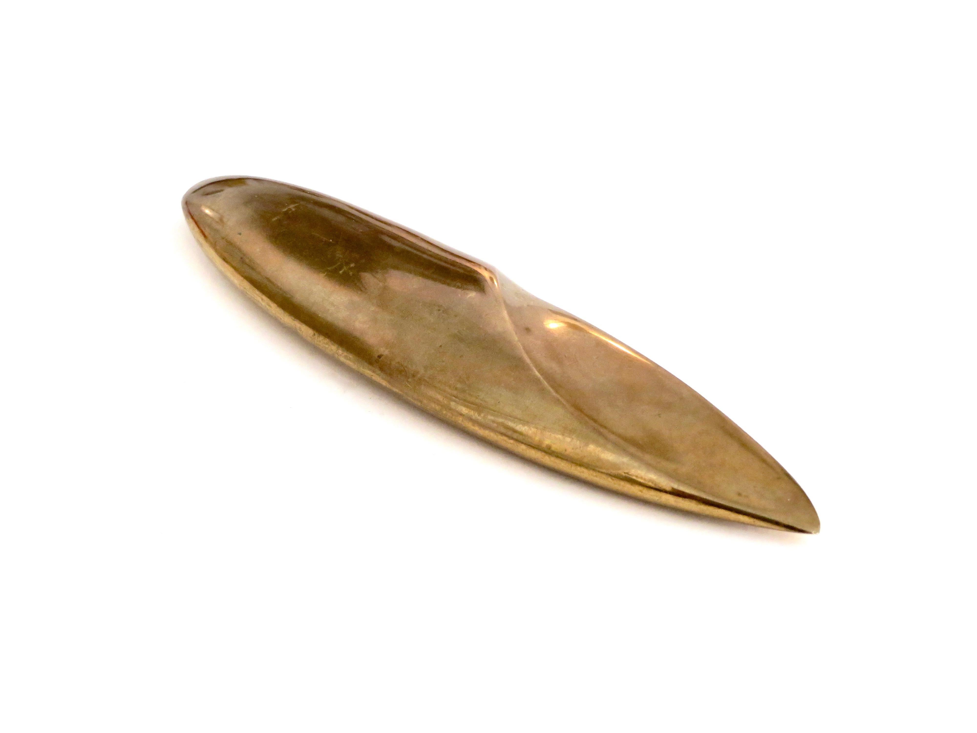 Monique Gerber bronze cast letter opener in a very sculptural and Minimalist form.
Can be used as a sculptural object or paper weight as well.
Reminiscent of a Brancusi form. 
Signed MG France.
Signs of use on the tip.
 