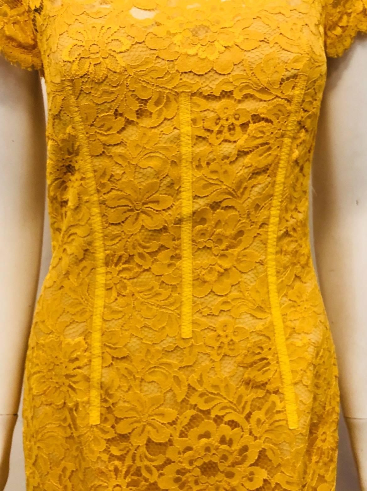 ML Monique Lhullier lemon amber lace dress with cap sleeves and open back diamond shape is fully lined in amber satin.  Hidden zipper at back for closure.   Great dress for spring/summer events. Body: 55% nylon 45% Rayon Liner: 90% Polyester 10%. 